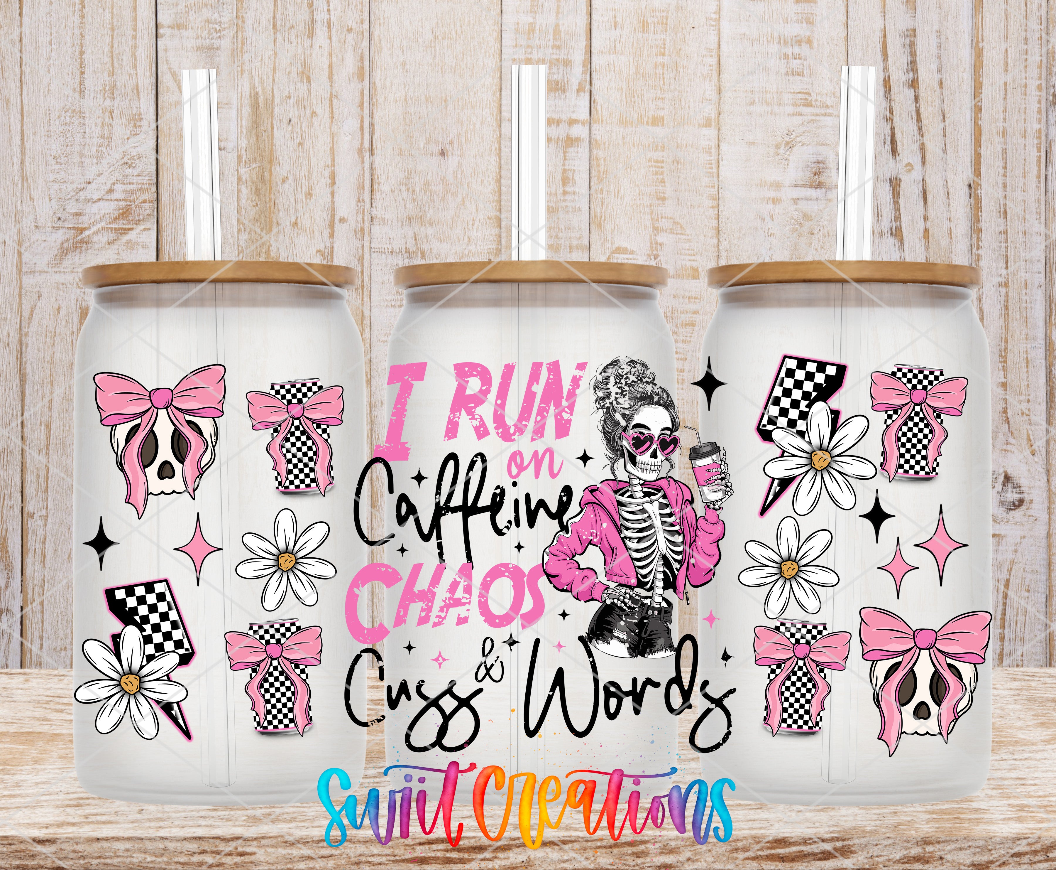 three glass tumblers with various designs and text printed on them.