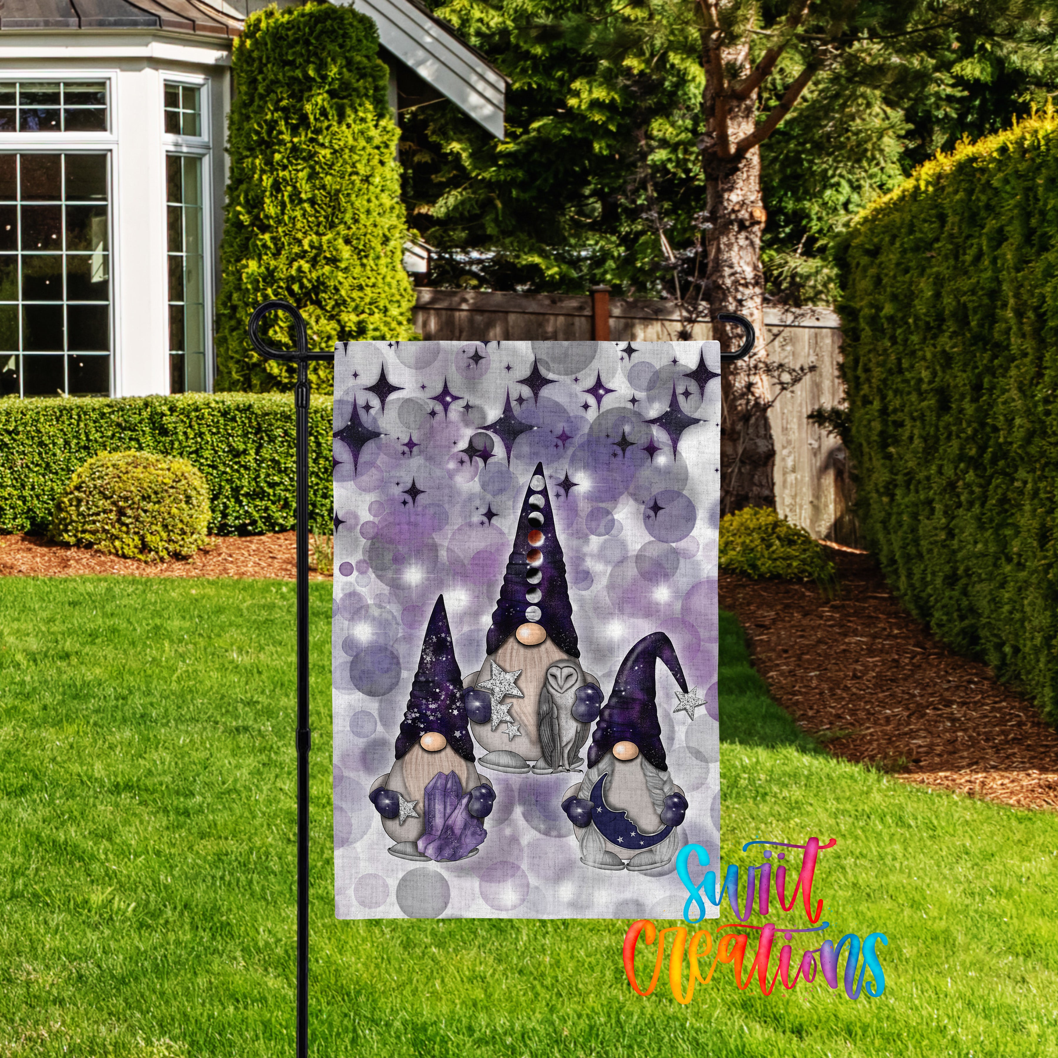 A garden flag featuring three gnomes with purple hats and star-patterned hair, set against a purple and white background with a starry night sky.