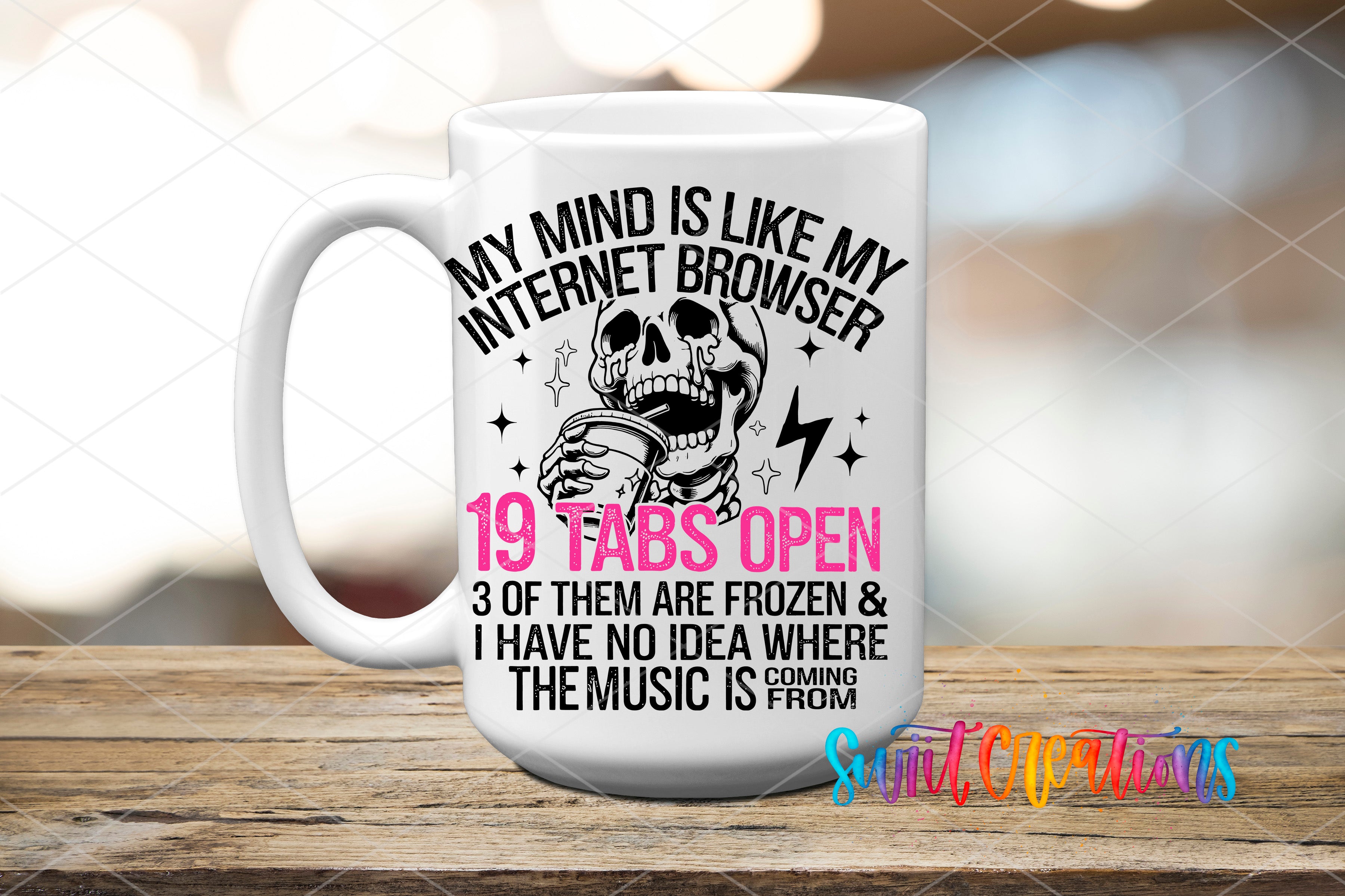 A white mug with a humorous text and graphic design on it, placed on a wooden surface.