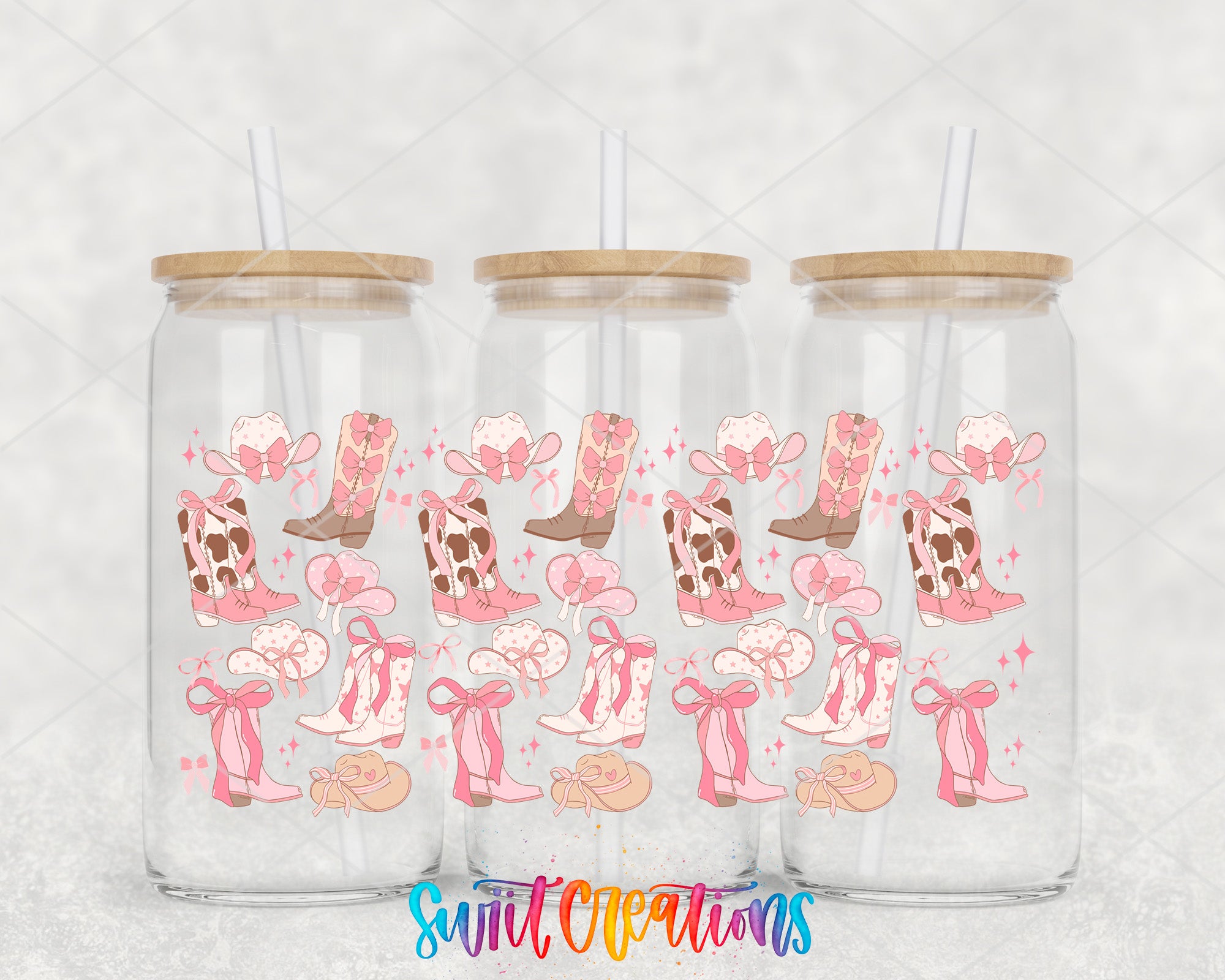 Three glass tumblers with straws, each decorated with a repeating pattern of pink cowboy boots and bows.
