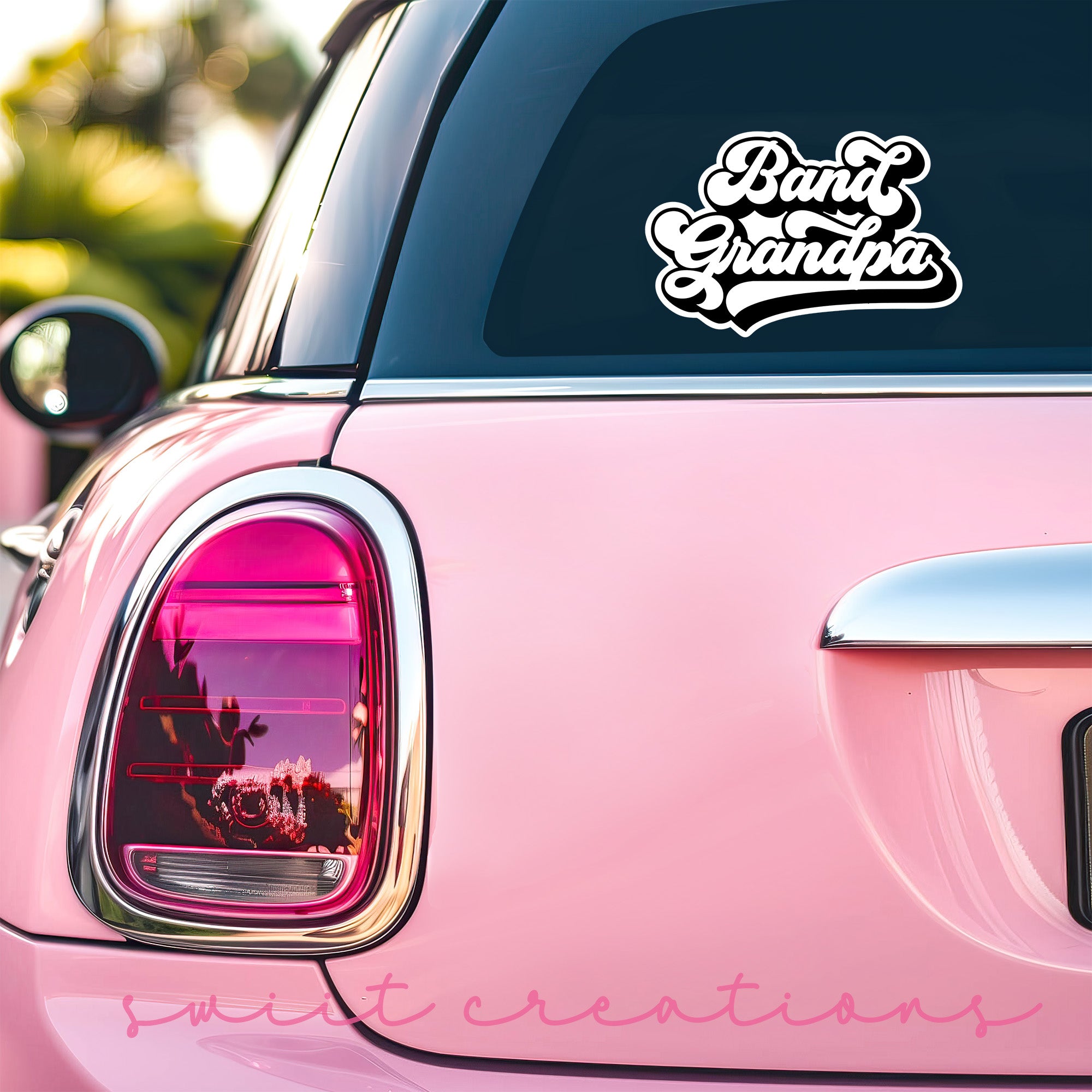 a pink car with a sticker on it