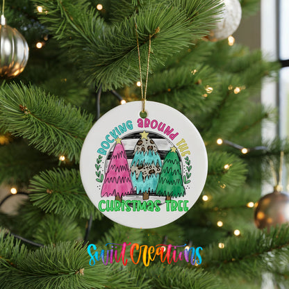 A Christmas tree ornament with the text "Rocking around the world" and "Christmas tree" is hanging on a decorated tree.