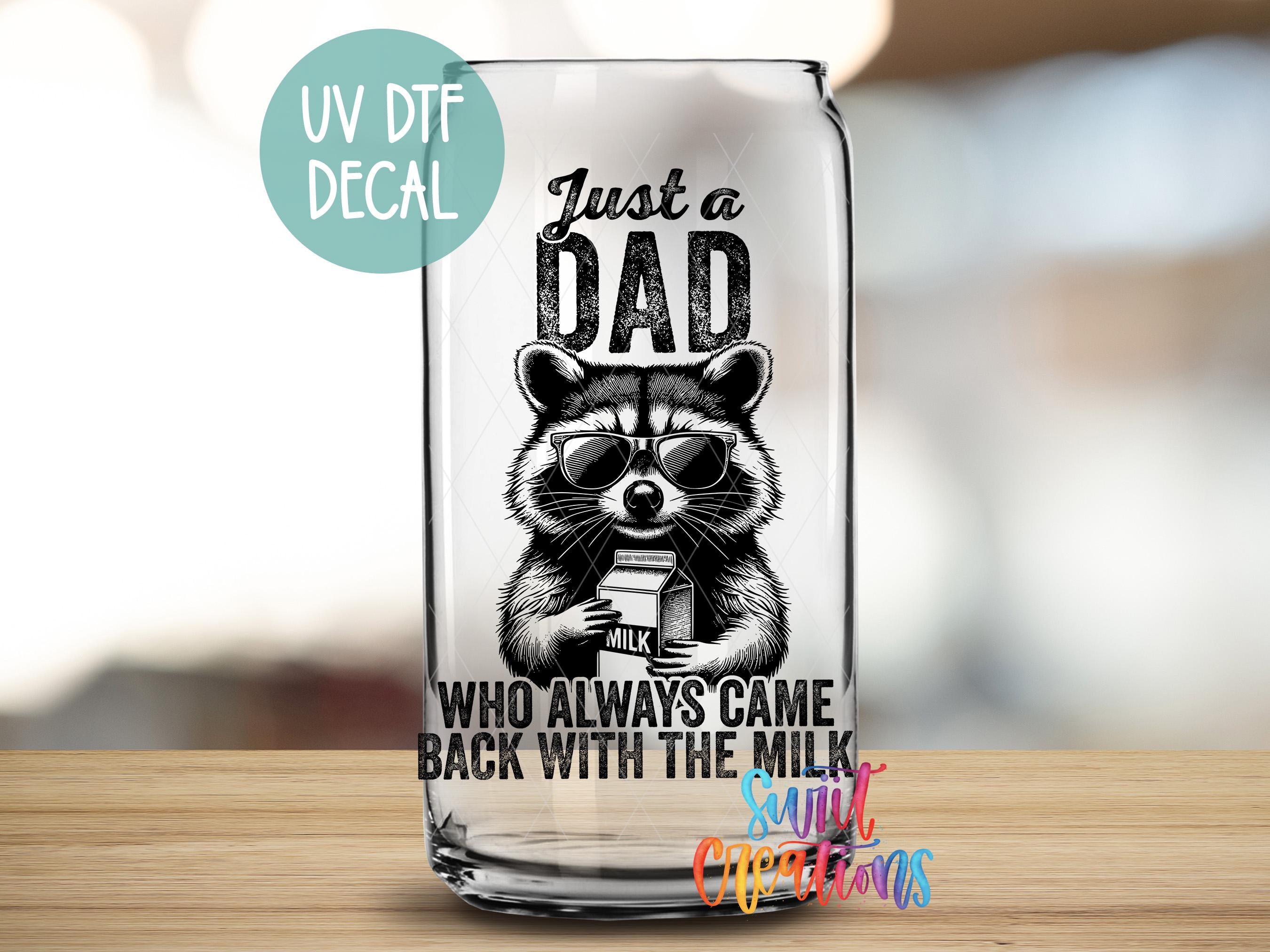 a glass with a raccoon on it that says just a dad who always
