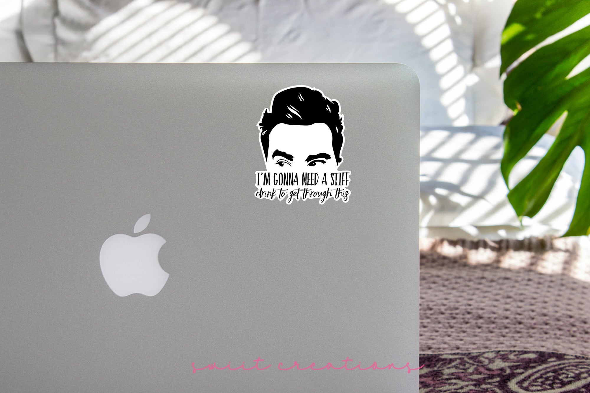 a laptop with a sticker of a man's face