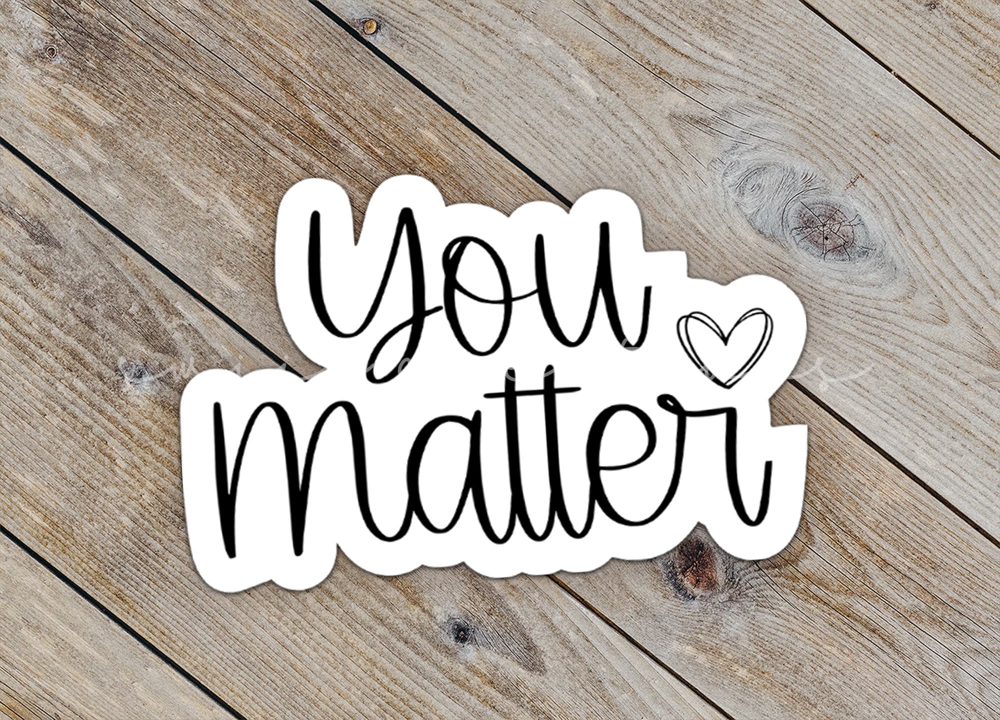 a sticker that says you matter on a wooden surface