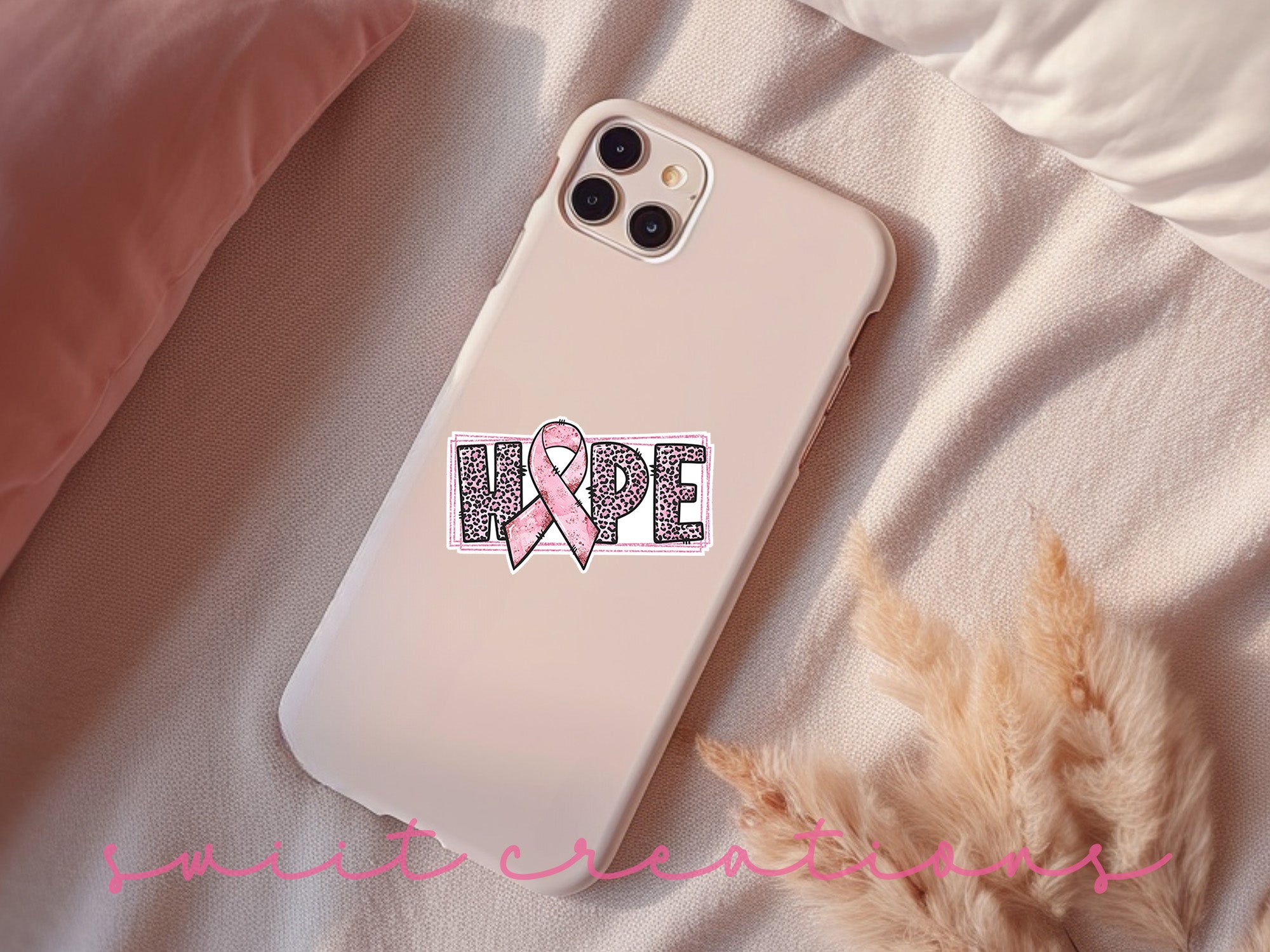 a phone case with a pink ribbon on it