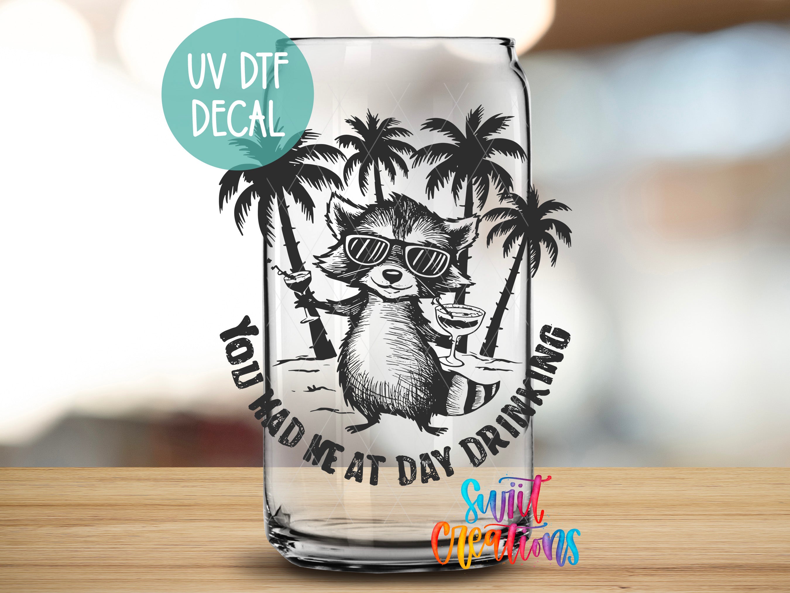 A glass can with a raccoon wearing sunglasses and holding a drink, surrounded by palm trees, with the text "You had me at day drinking" and "UV Dtf Decal" printed on it.