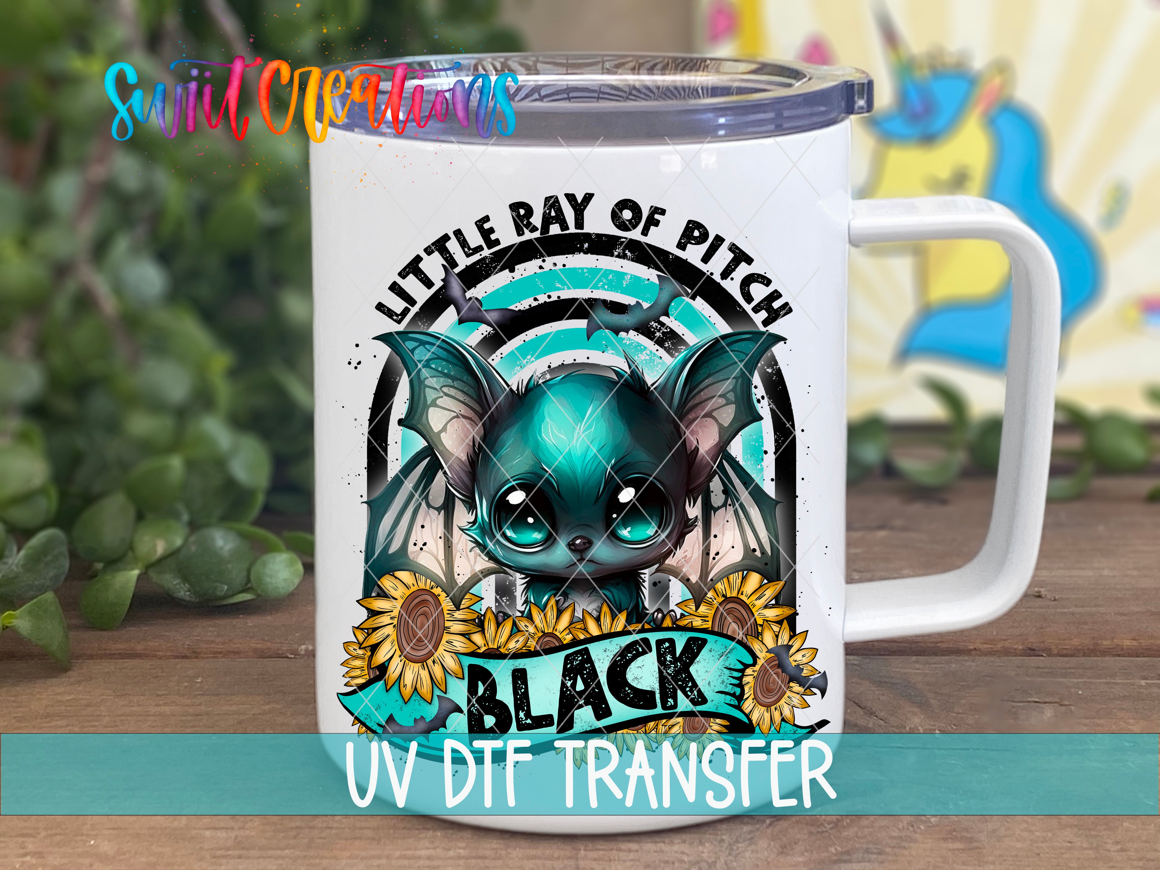 A white mug with a colorful design featuring a bat-like creature, sunflowers, and the text "LITTLE RAY OF PITCH" and "BLACK UV DIFF TRANSFER".
