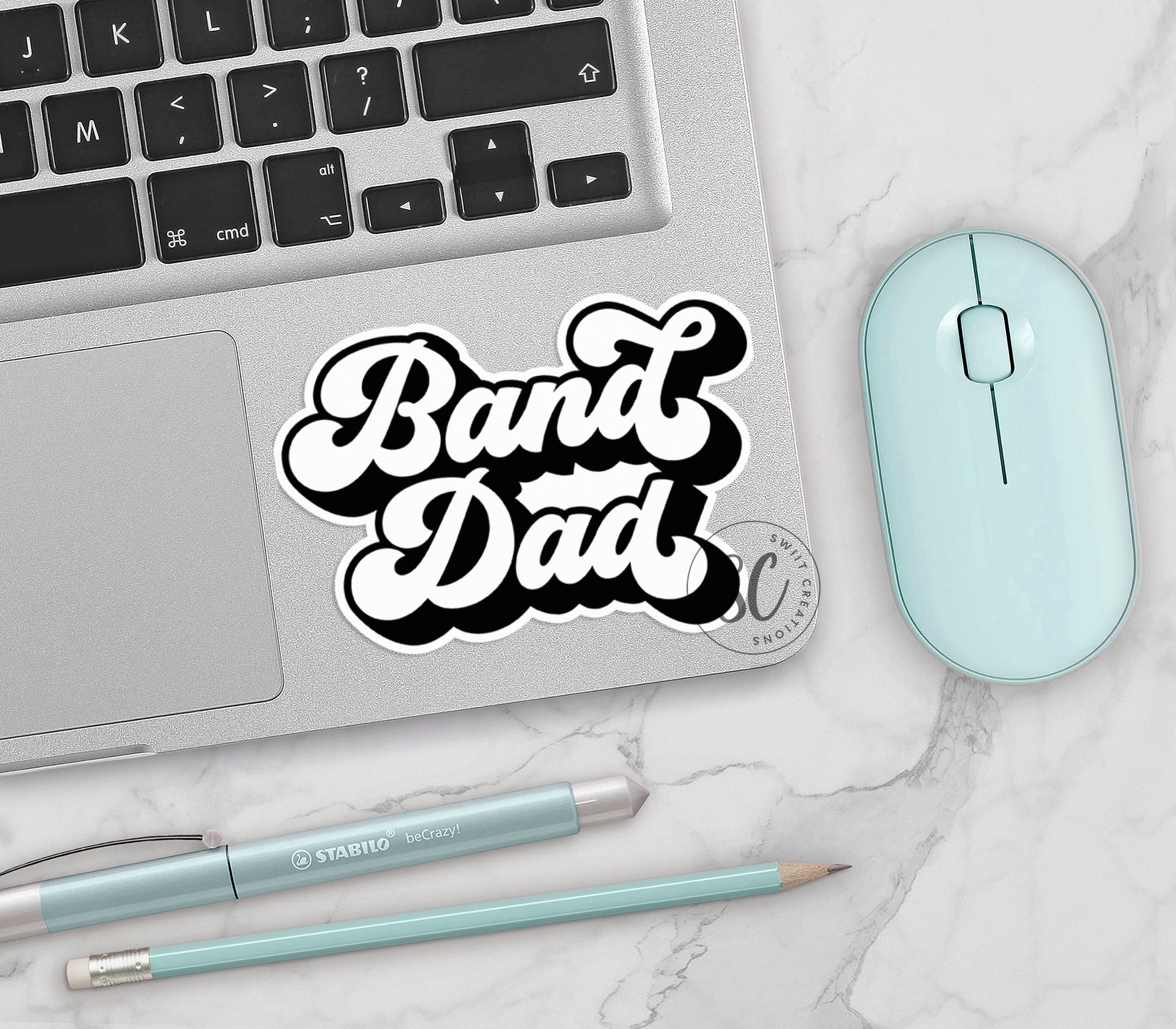 a sticker that says band dad next to a mouse and keyboard