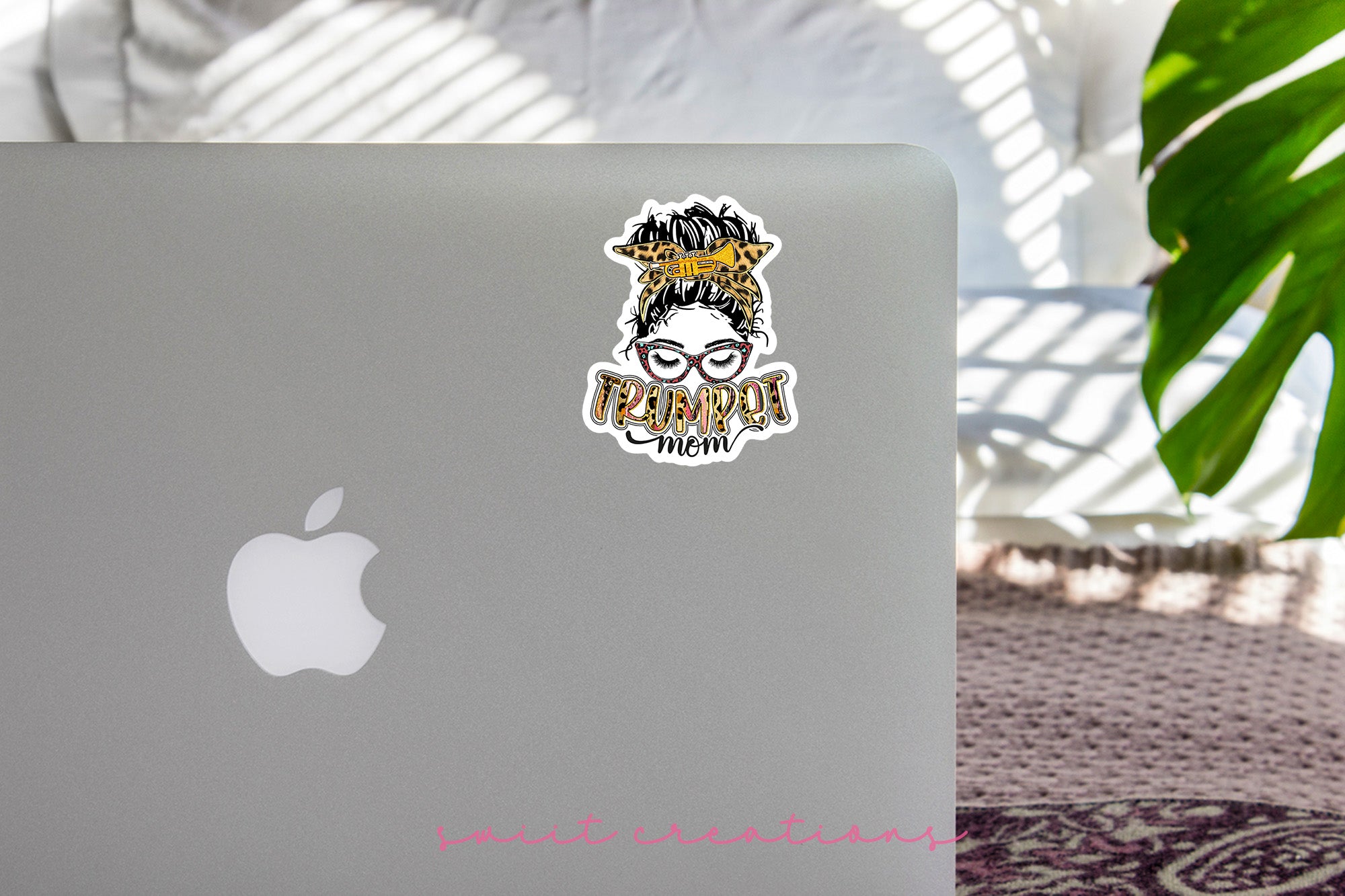 a laptop with a sticker of a woman with a crown on her head