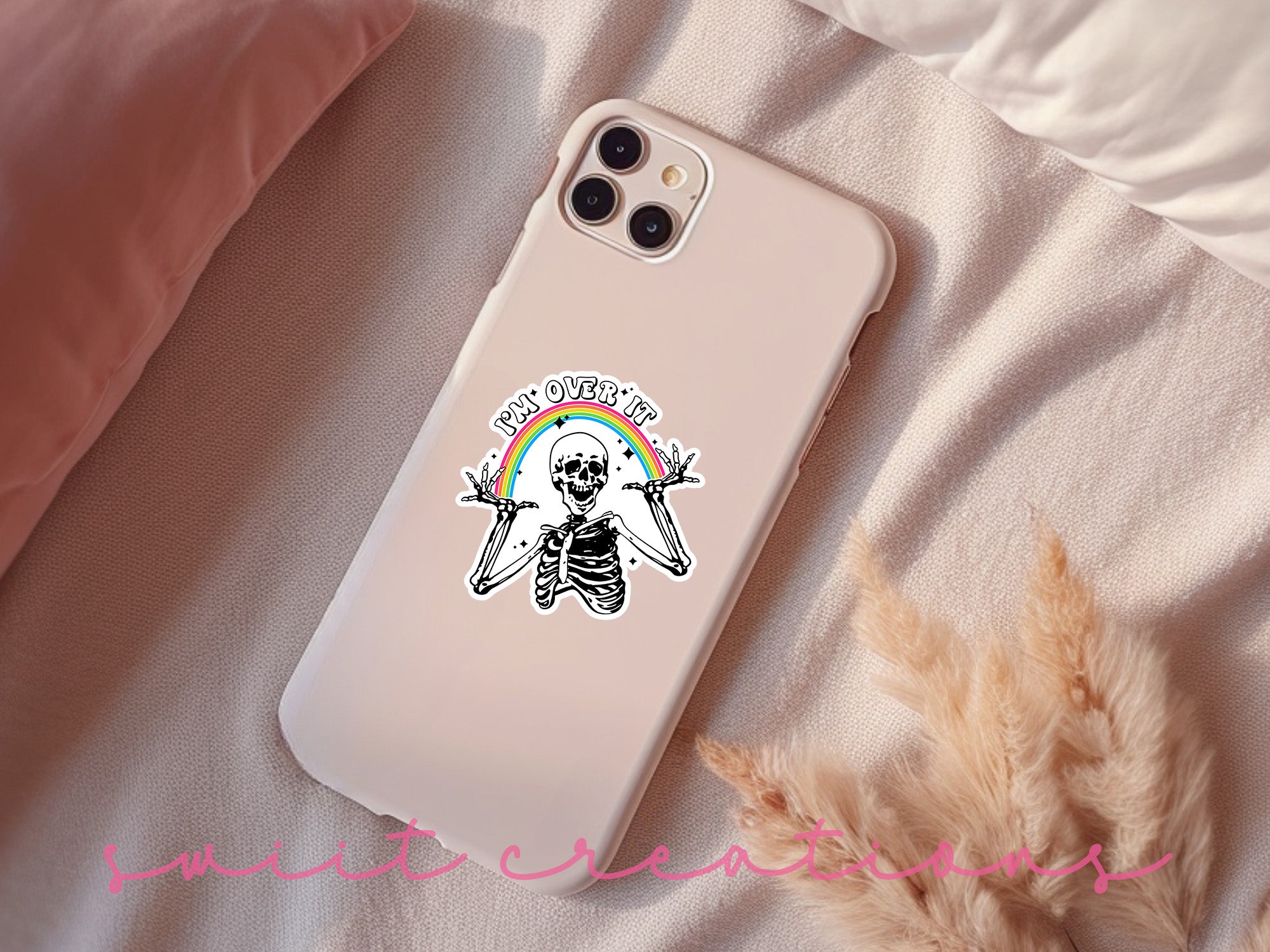a phone case with a skeleton holding two swords