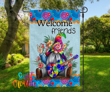 A colorful garden gnome holding a guitar and surrounded by flowers and other garden elements, with the text "Welcome friends" displayed on the gnome.