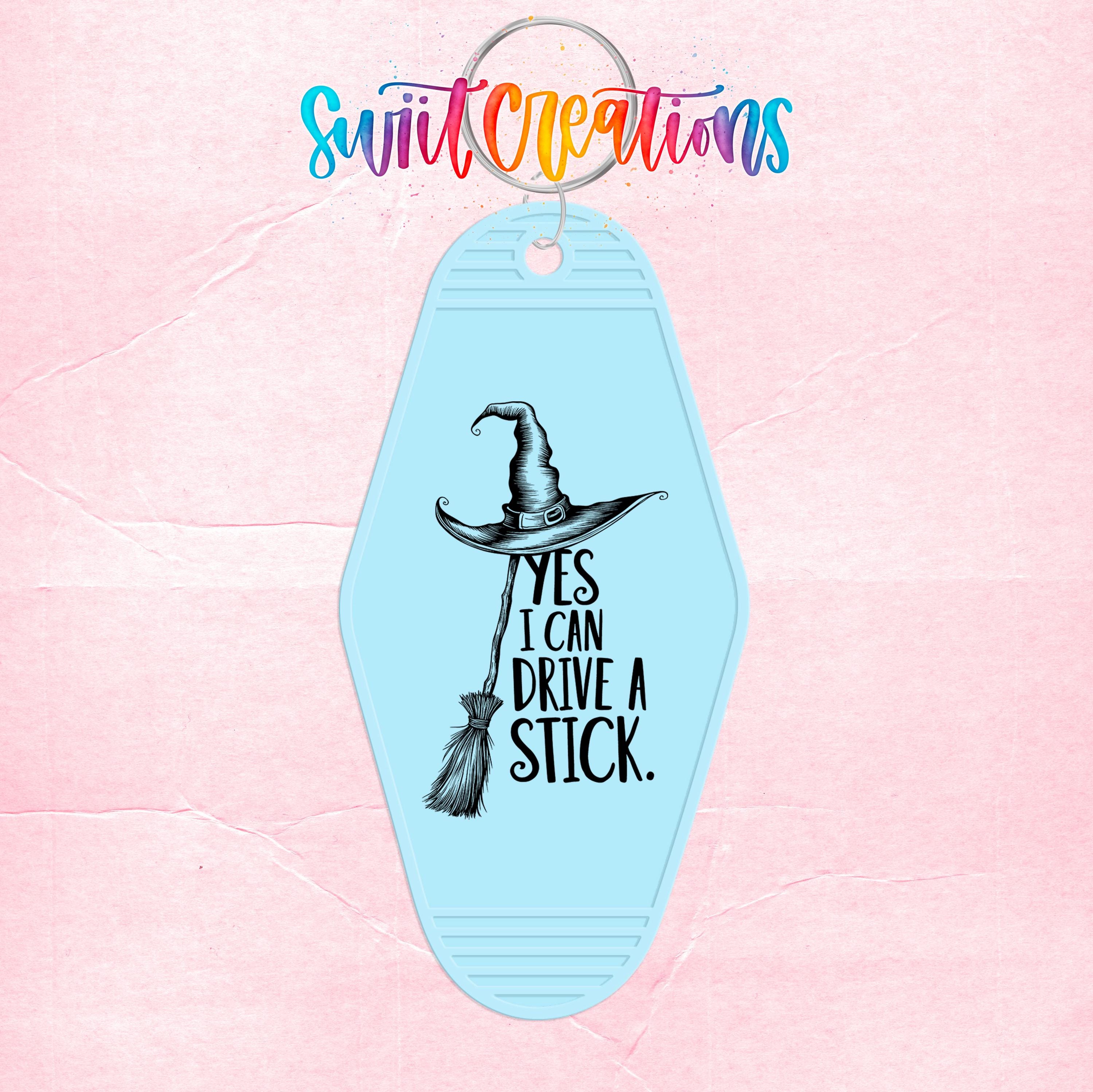 A keychain with a witch's hat and the text "YES I CAN DRIVE A STICK" printed on it.