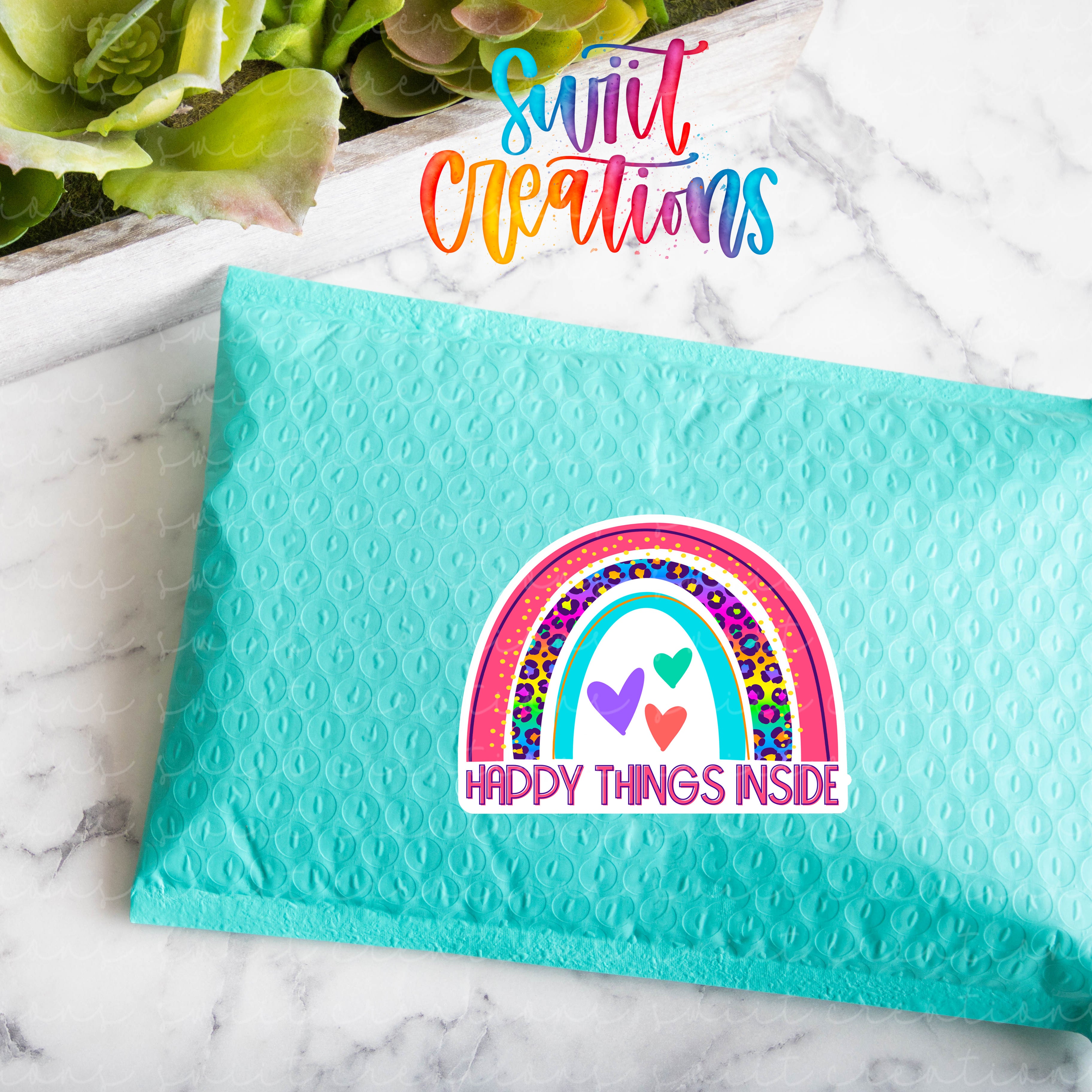 a blue envelope with a rainbow sticker on it