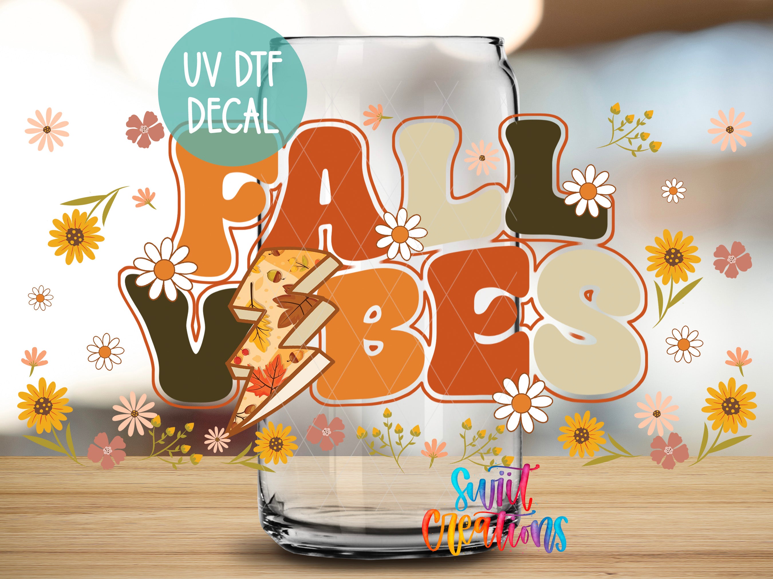 a glass jar with a UV decal that says "FALL VIBES" surrounded by autumn-themed elements such as flowers and leaves.