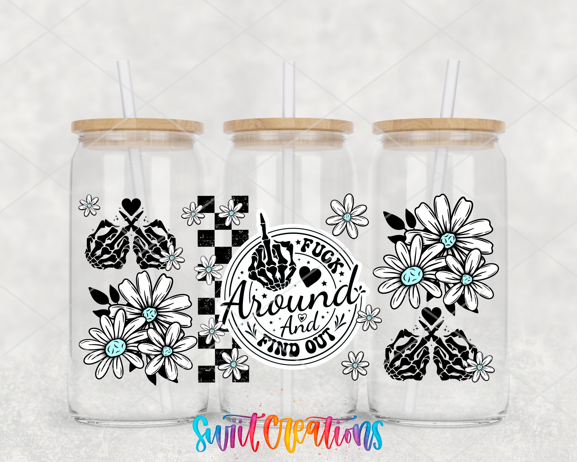 three glass tumblers with black and white floral designs and text.