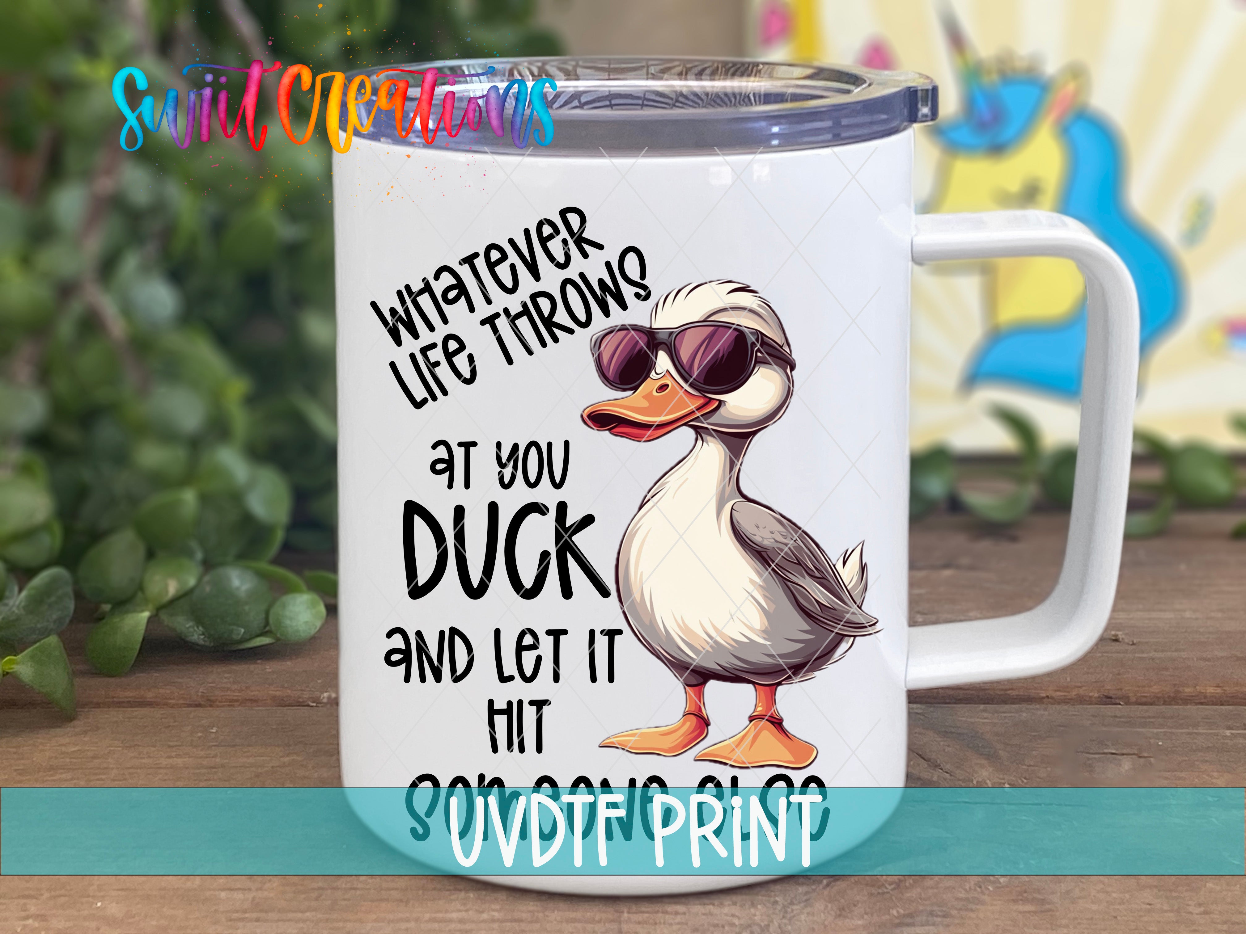 A white mug with a cartoon duck wearing sunglasses and the text "Whatever life throws at you, duck and let it hit you" printed on it.