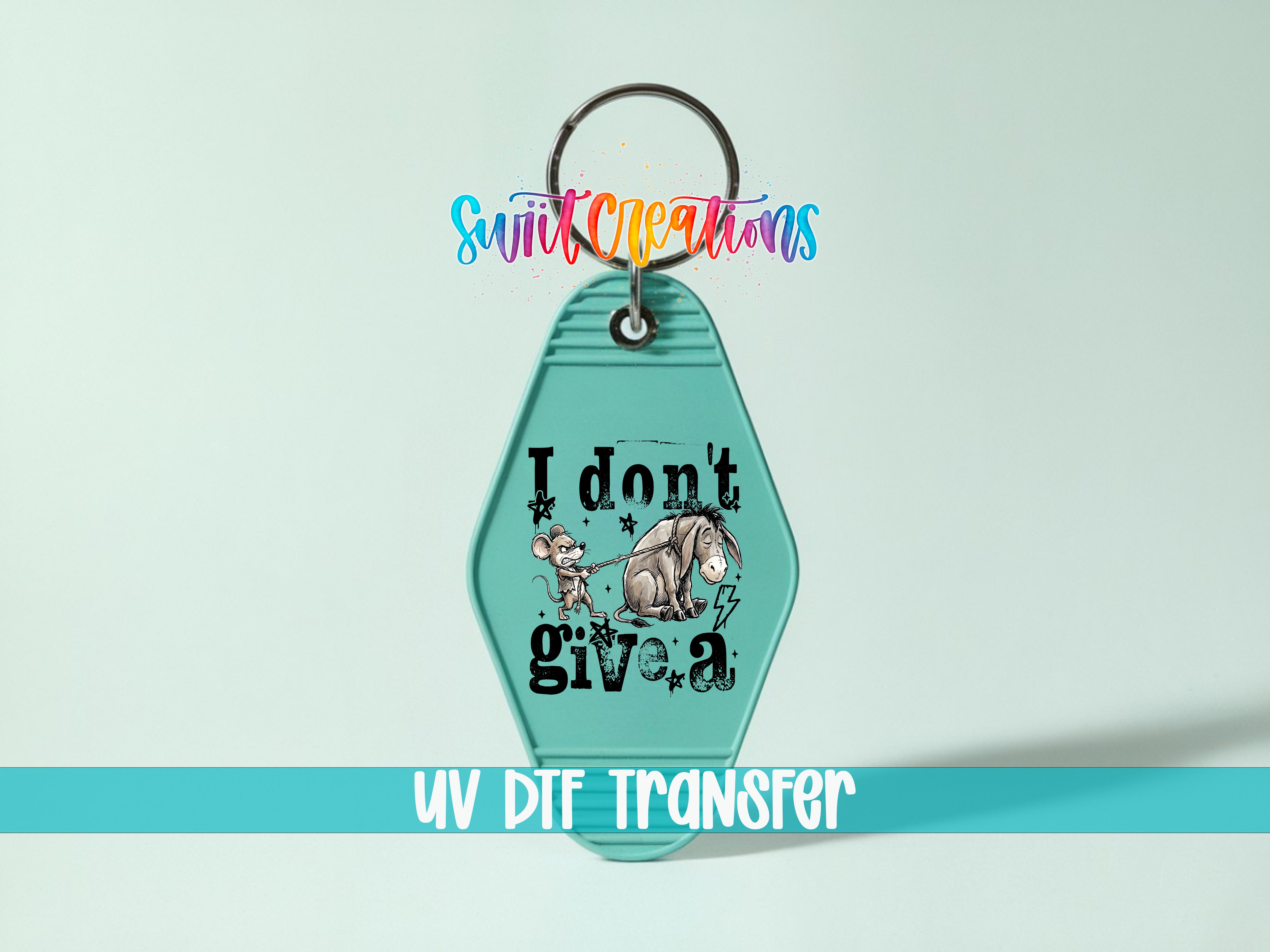 A keychain with a cartoon image of Eeyore and a mouse, along with the text "I don't give a" printed on it.