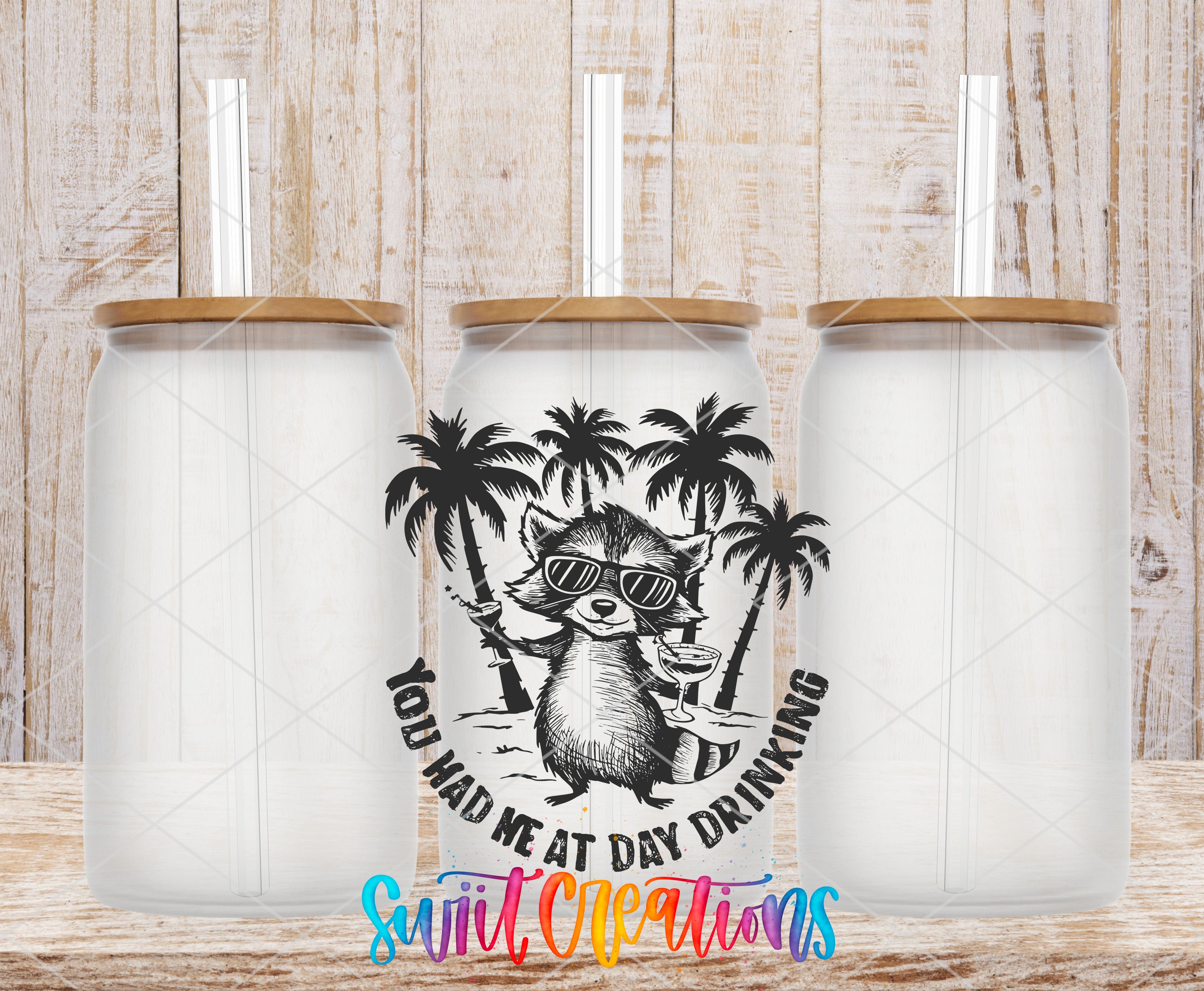 A black and white illustration of a raccoon wearing sunglasses and holding a drink, with palm trees in the background, is displayed in front of three identical white glass tumblers with wooden lids.