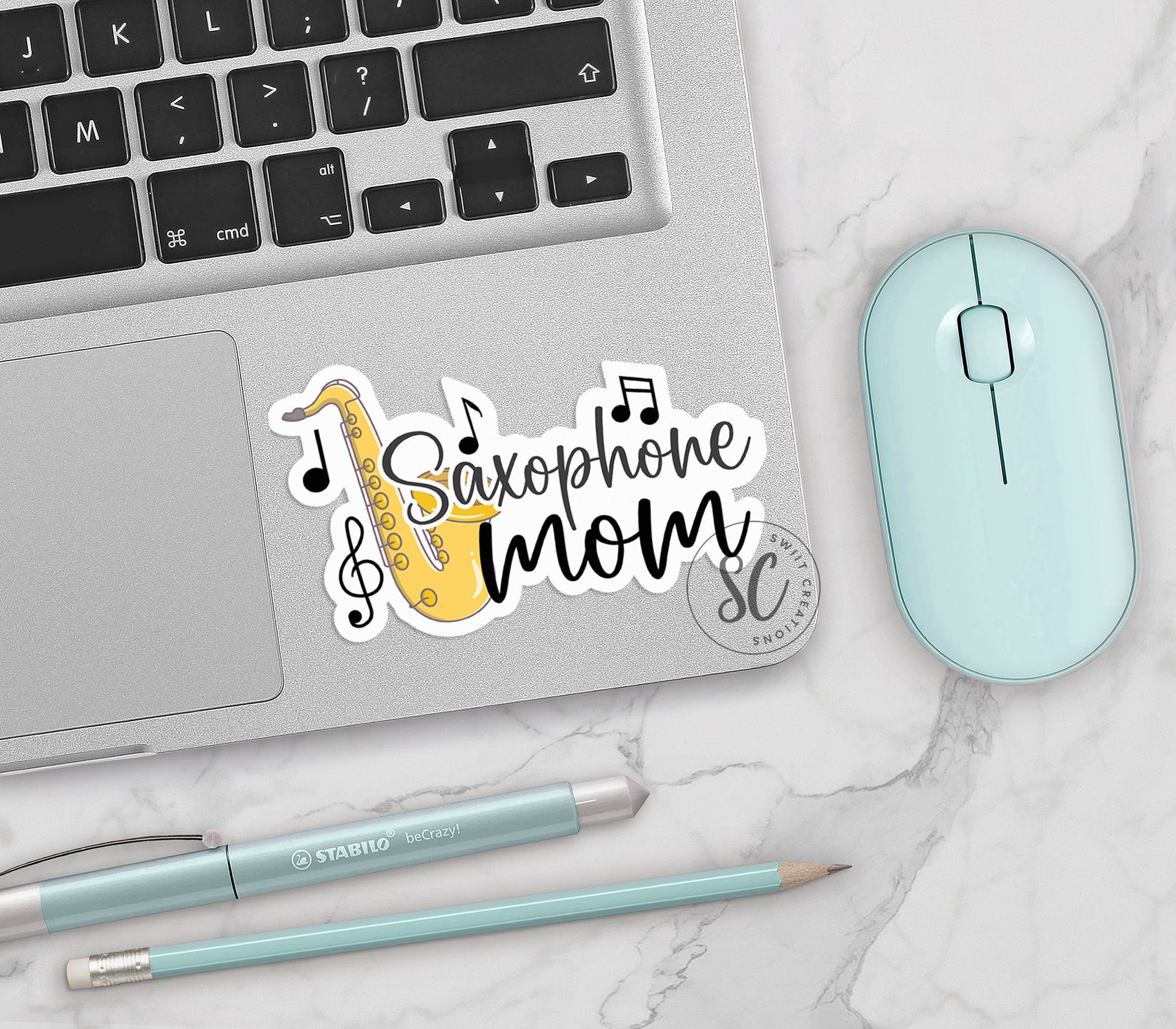 a keyboard, mouse, and sticker on a table