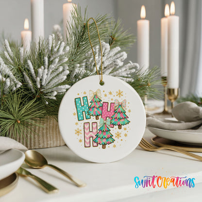 A white ceramic ornament with a colorful design hangs on a table, surrounded by candles and greenery.
