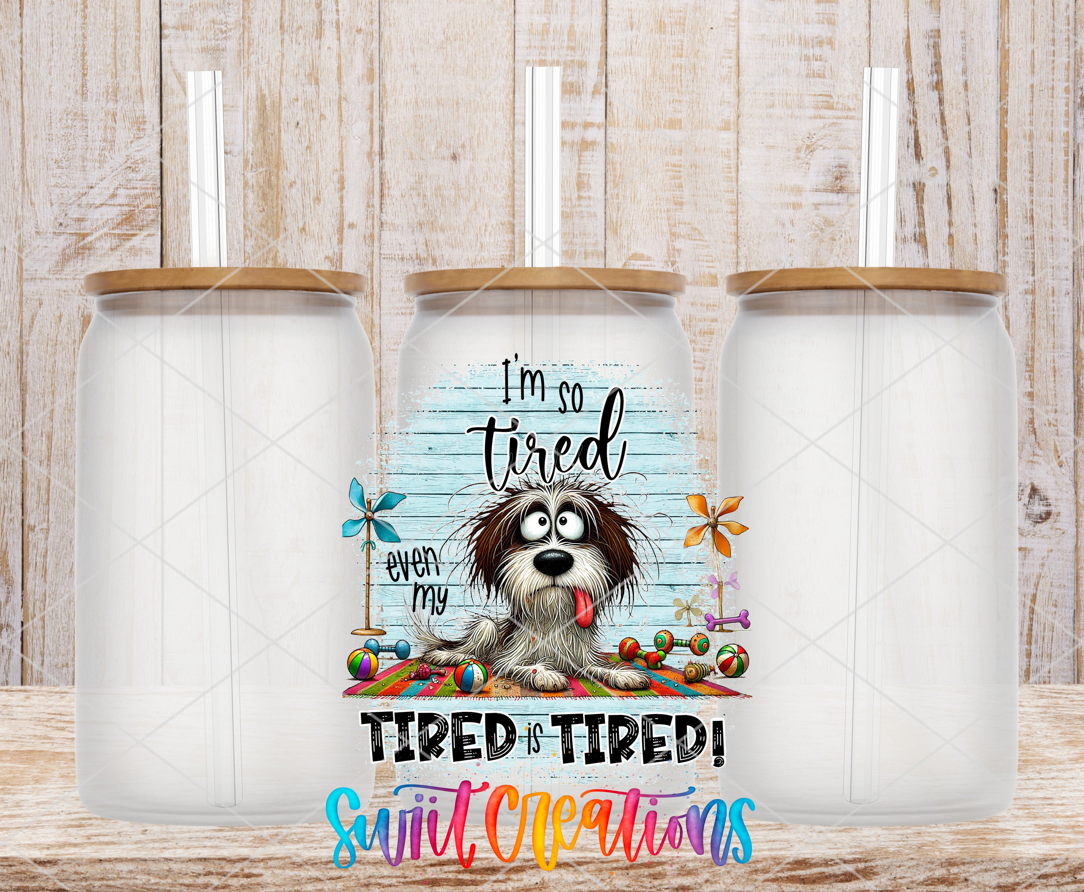 A tumbler with a straw, featuring a cartoon image of a dog and the text "I'm so tired, even my tired is tired!"