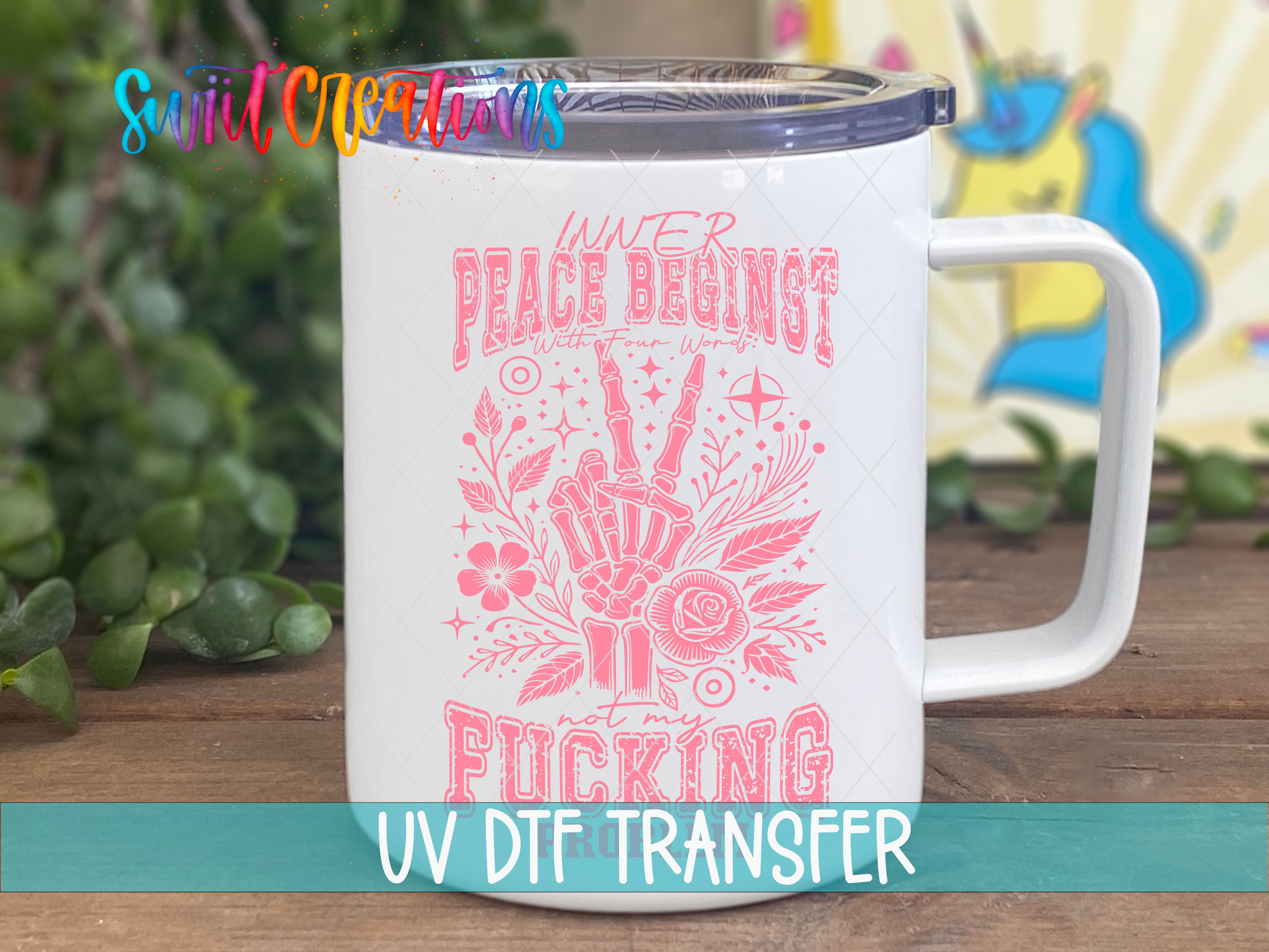A white mug with a pink and black design featuring a skeleton hand and the text "WATER PEACE BEGINS WITH FUCKING" printed on it.