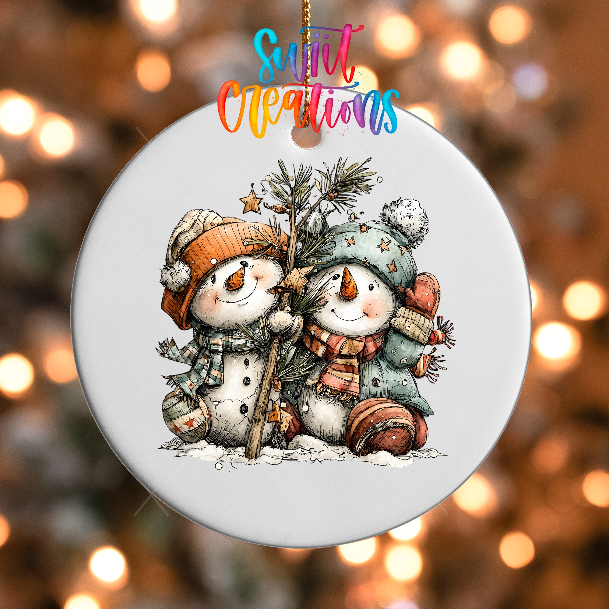 A snowman ornament with two snowmen, one wearing a red hat and the other wearing a blue hat, holding a pine tree.