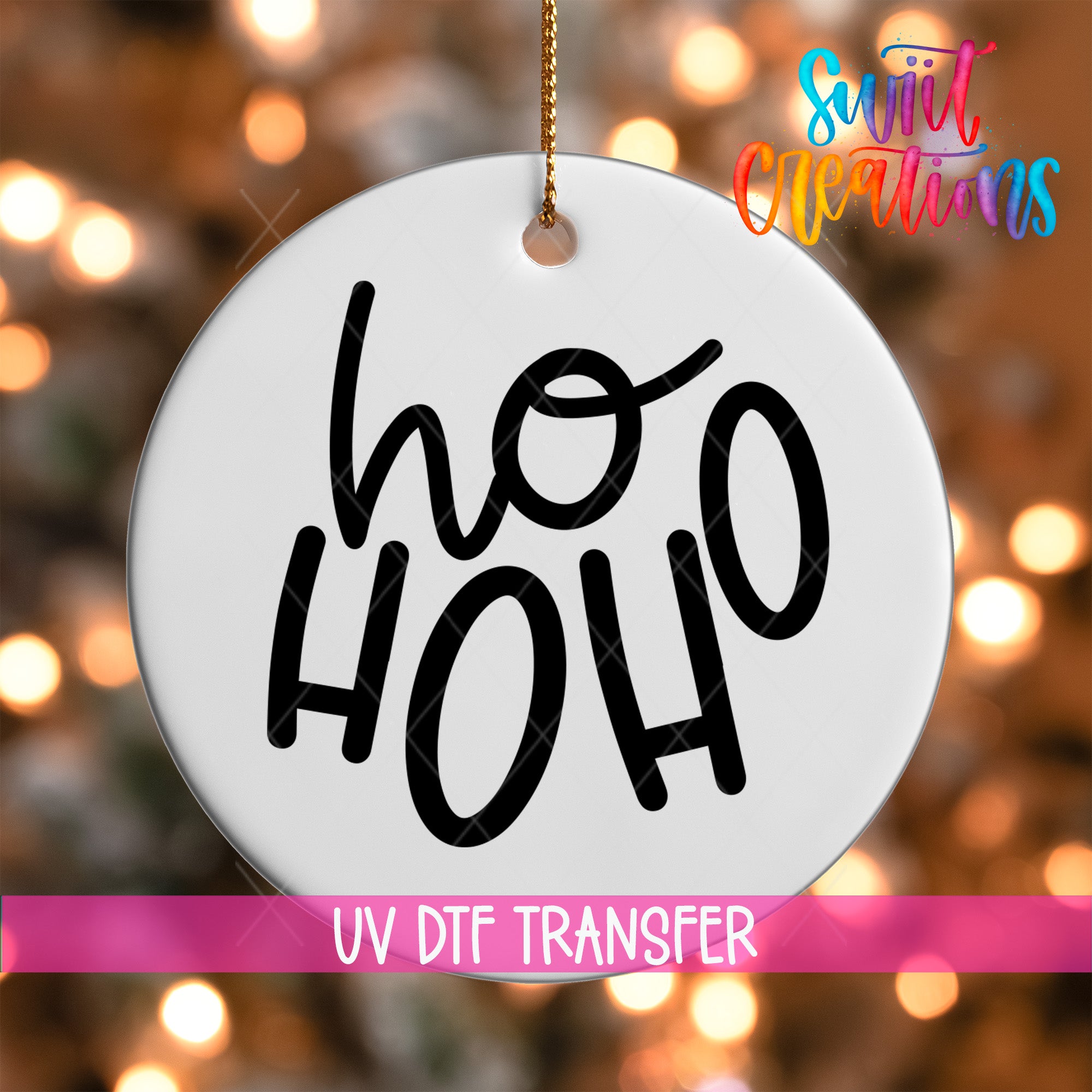 A white ornament with the text "ho ho" in black cursive letters.