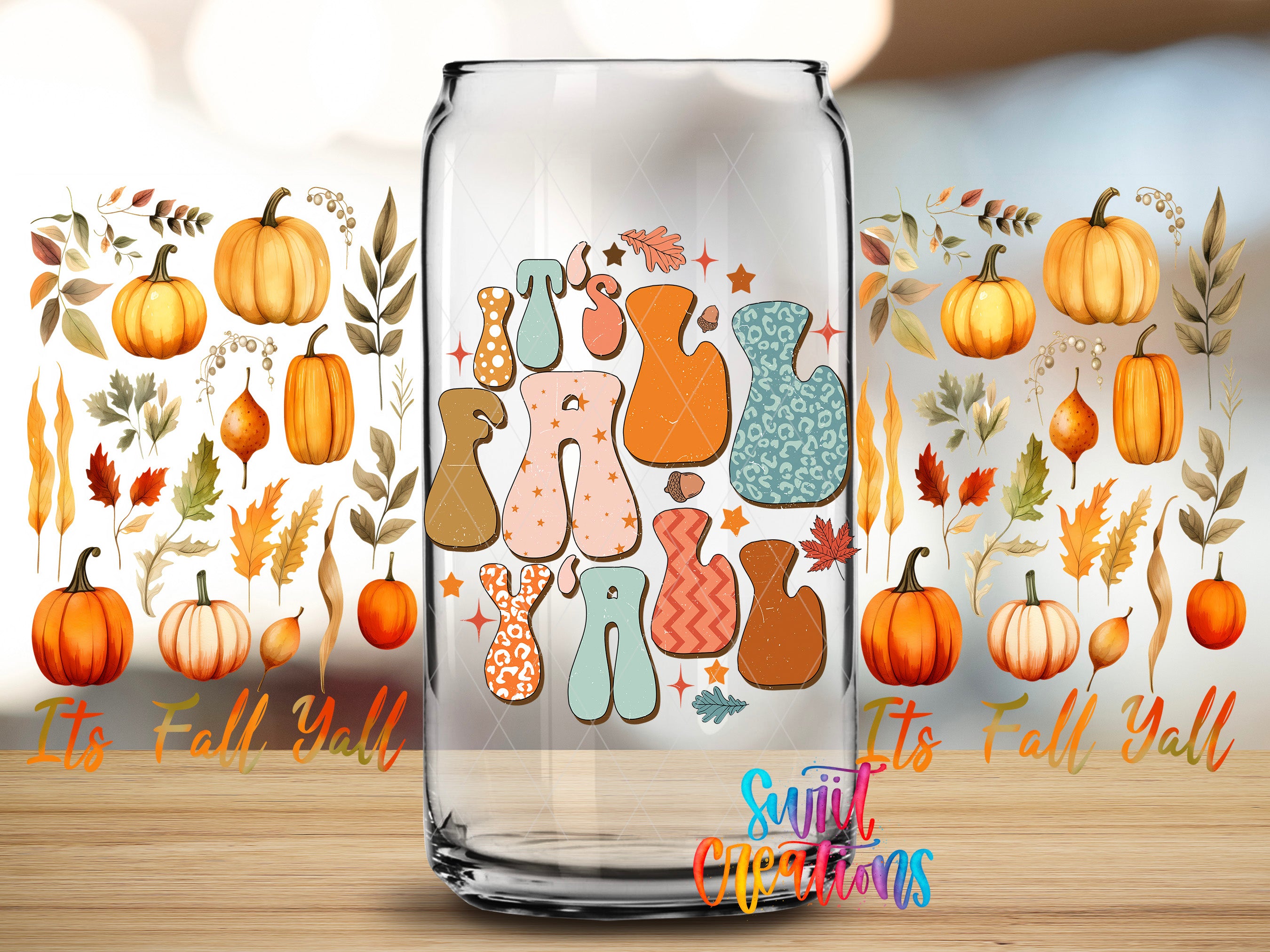 a glass jar with a colorful design of fall-themed graphics, including pumpkins, leaves, and other autumn elements. The jar is placed on a wooden surface, and there is text surrounding the jar that reads "It's Fall Yell" and "It's Fall Yell".
