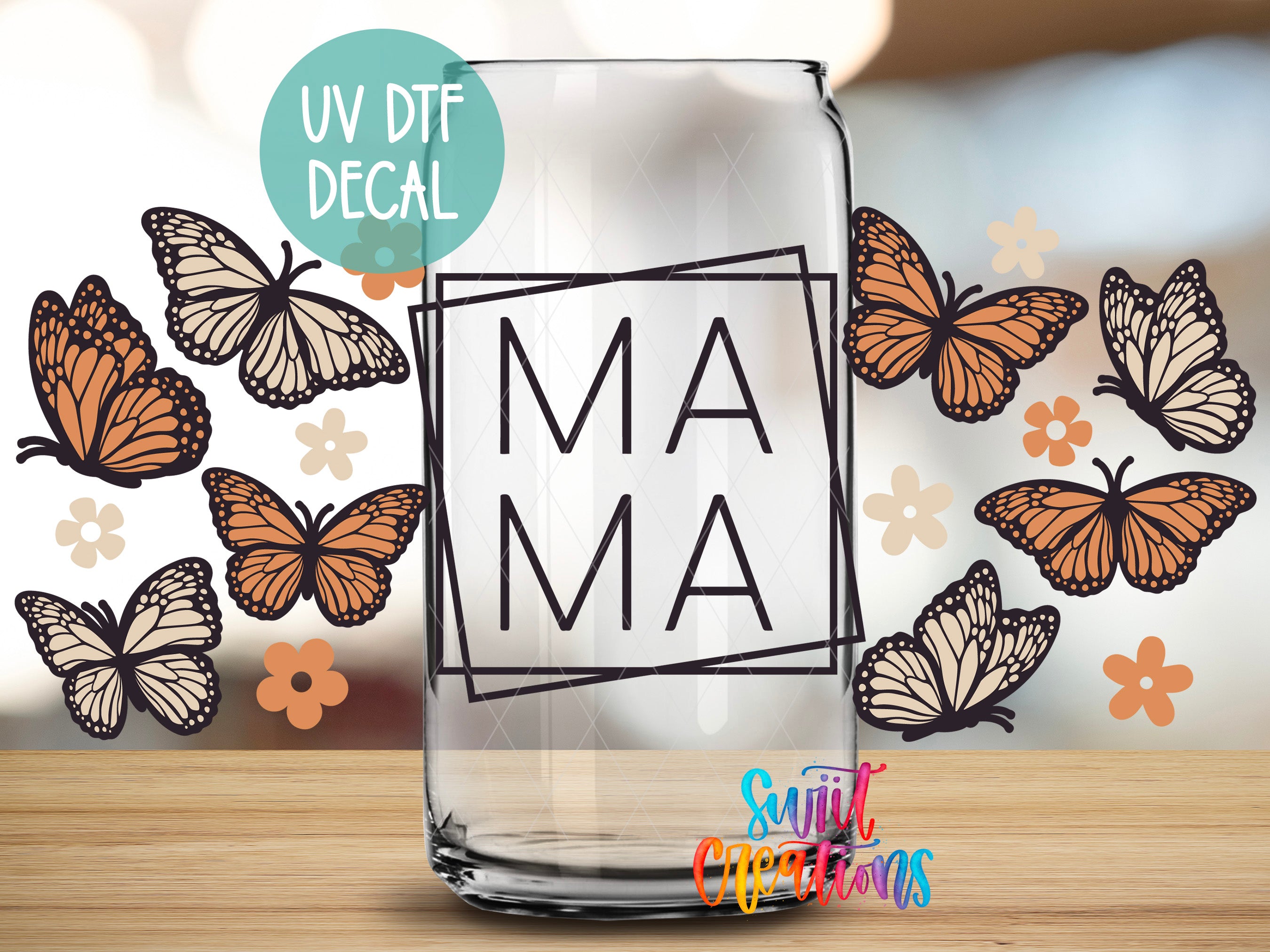 a clear glass jar with a UV decal that says "MAMA" in bold letters, surrounded by various butterflies and flowers.