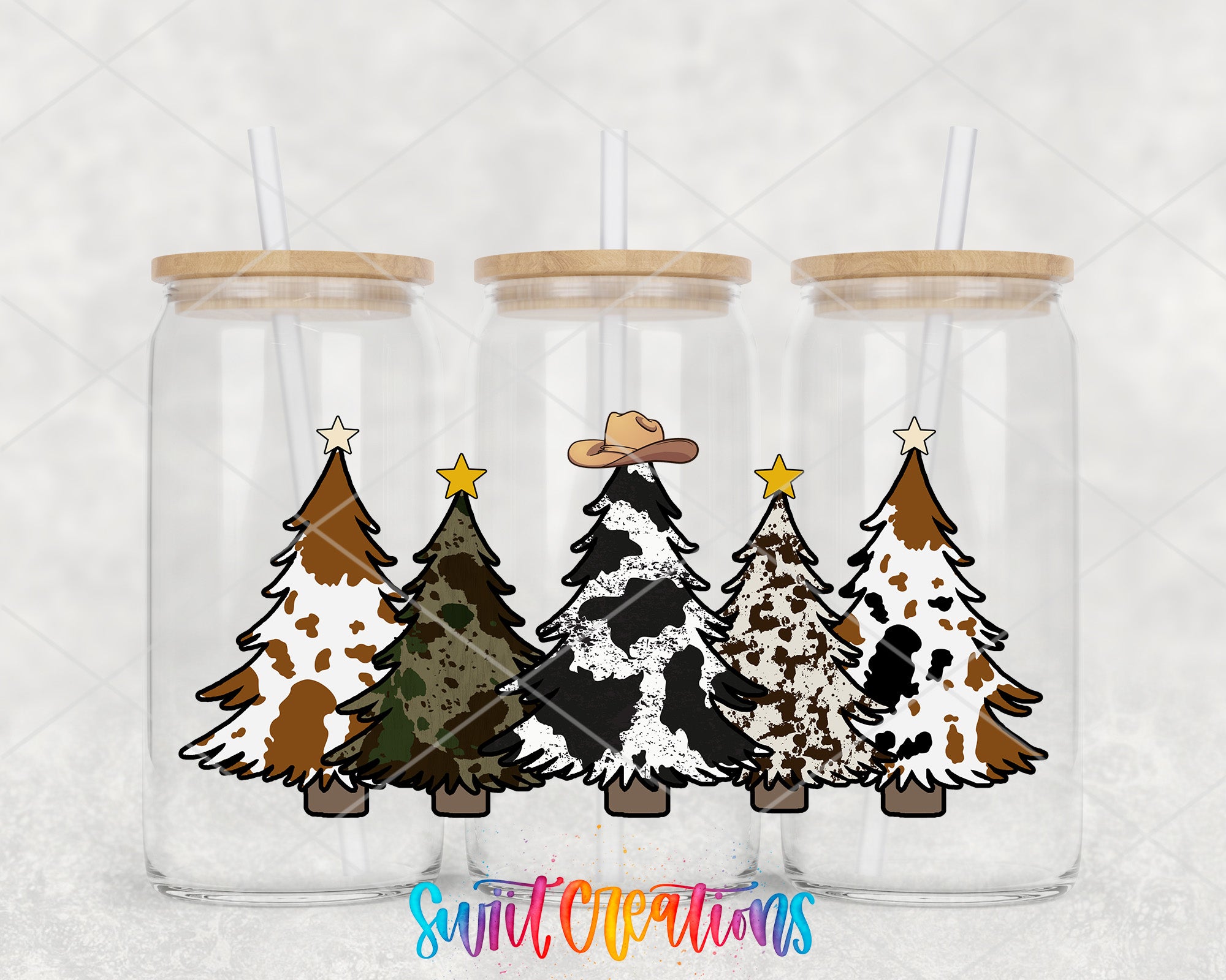 Three glass jars with wooden lids, each containing a Christmas tree with a cowboy hat on top.