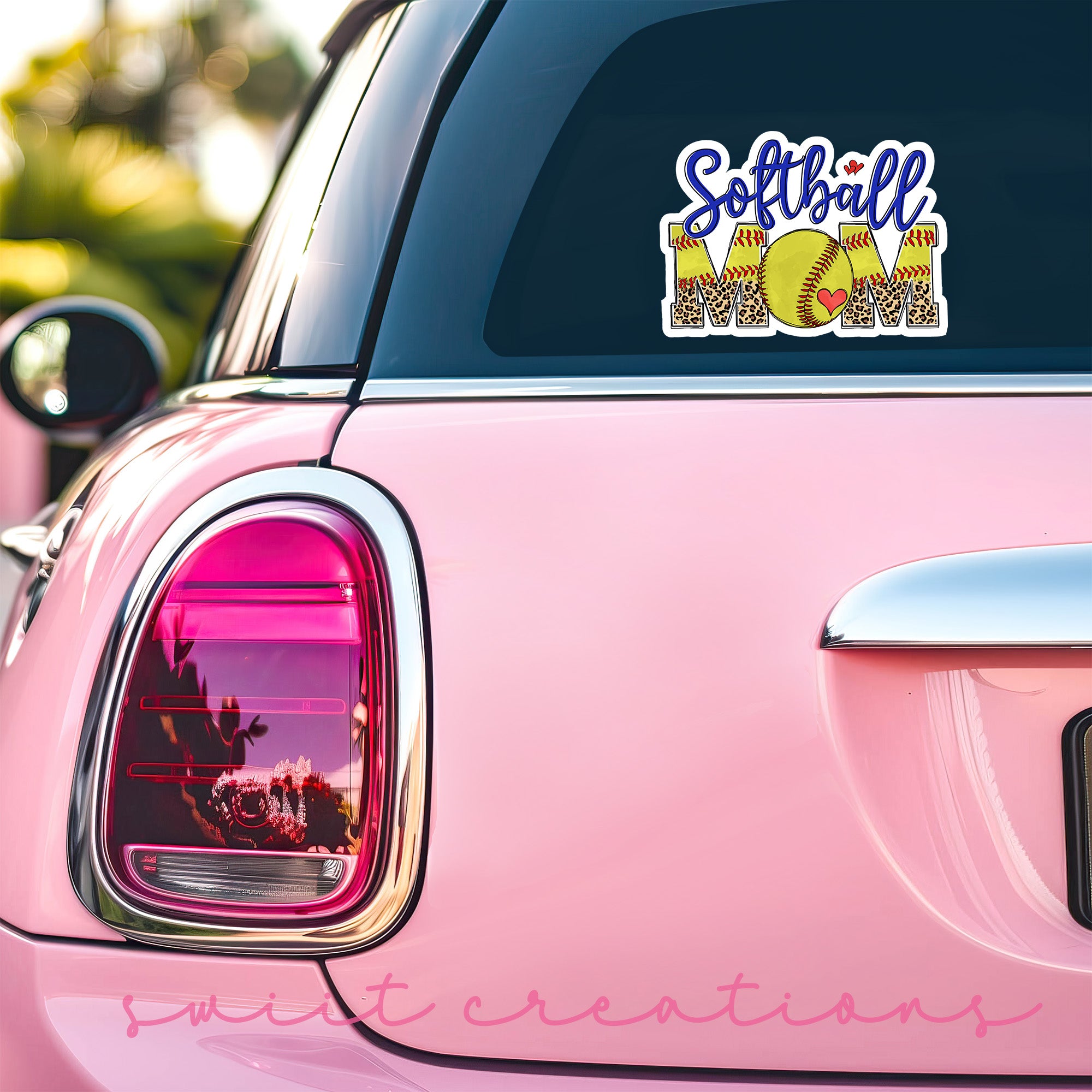 a pink car with a softball sticker on it