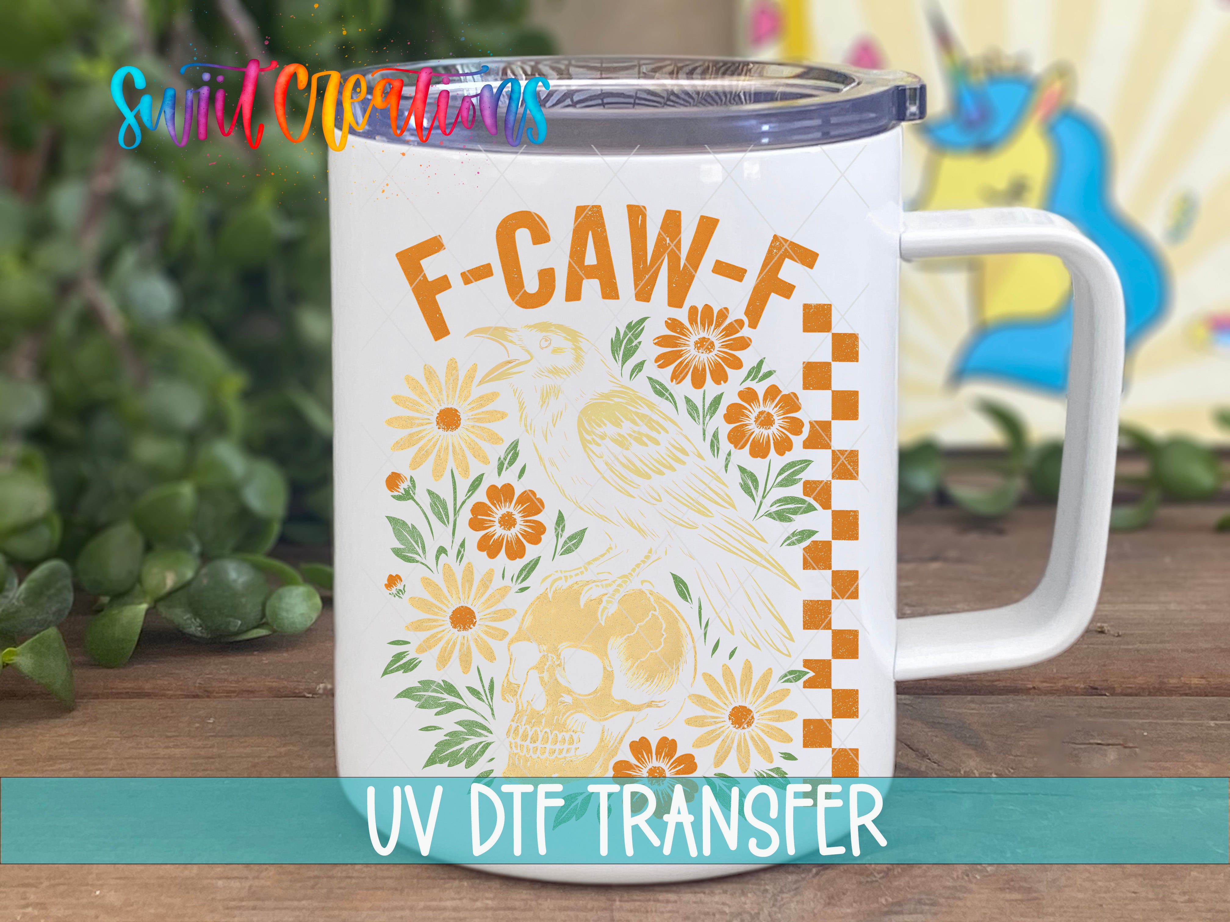 A white mug with a floral design and a bird on it, placed on a wooden surface.