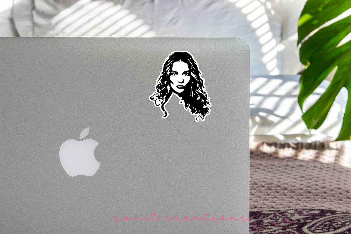 a laptop with a sticker of a woman's face