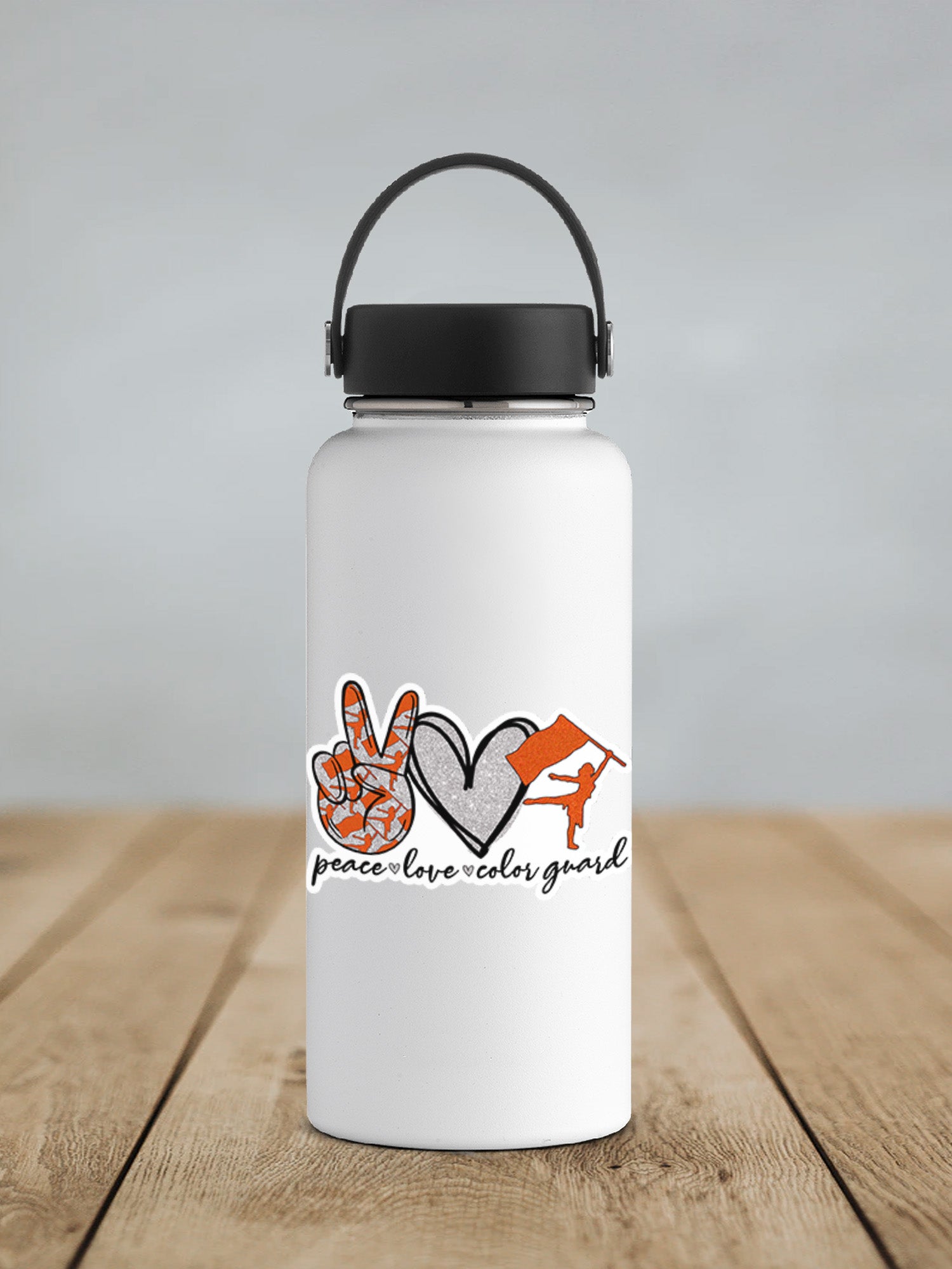 a white water bottle sitting on top of a wooden table