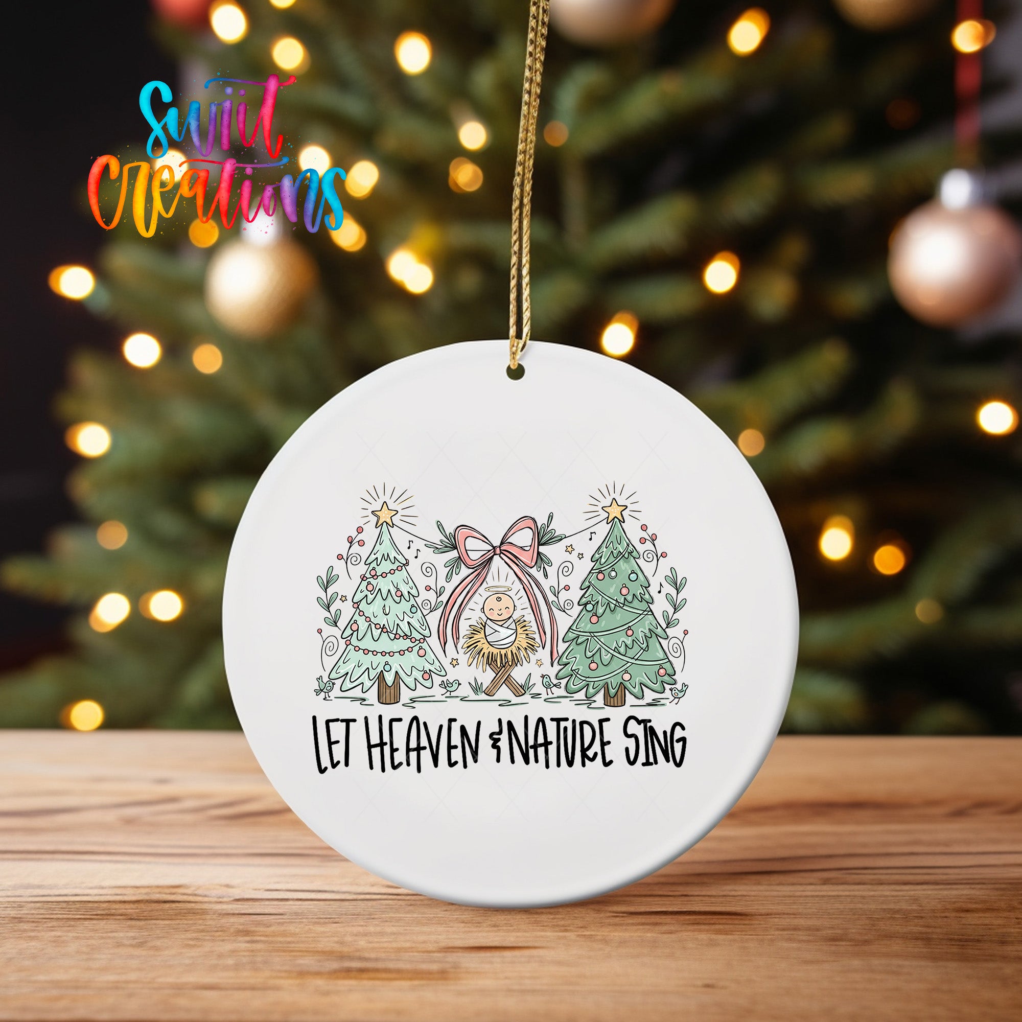 A white ceramic ornament with a Christmas tree design and the text "Let Heaven #Nature Sing" hanging from a string.
