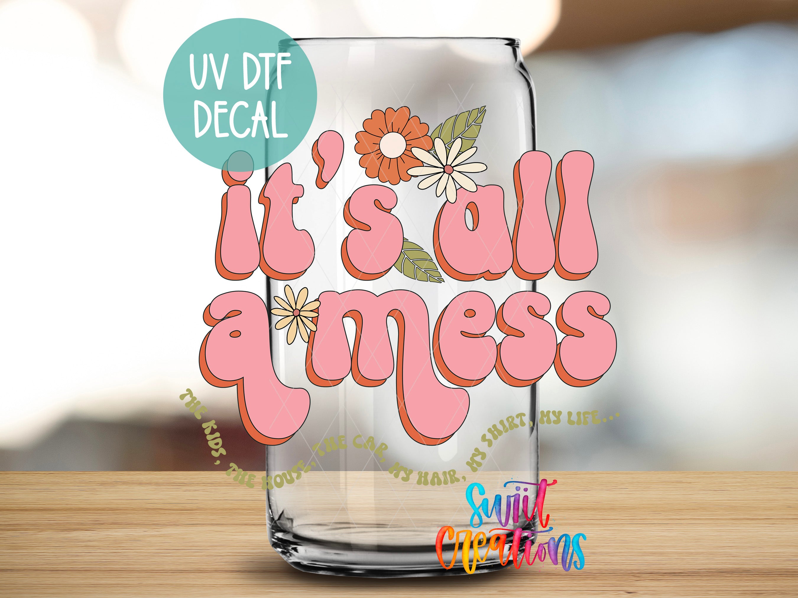 a glass jar with a decorative text design on it, placed on a wooden surface.