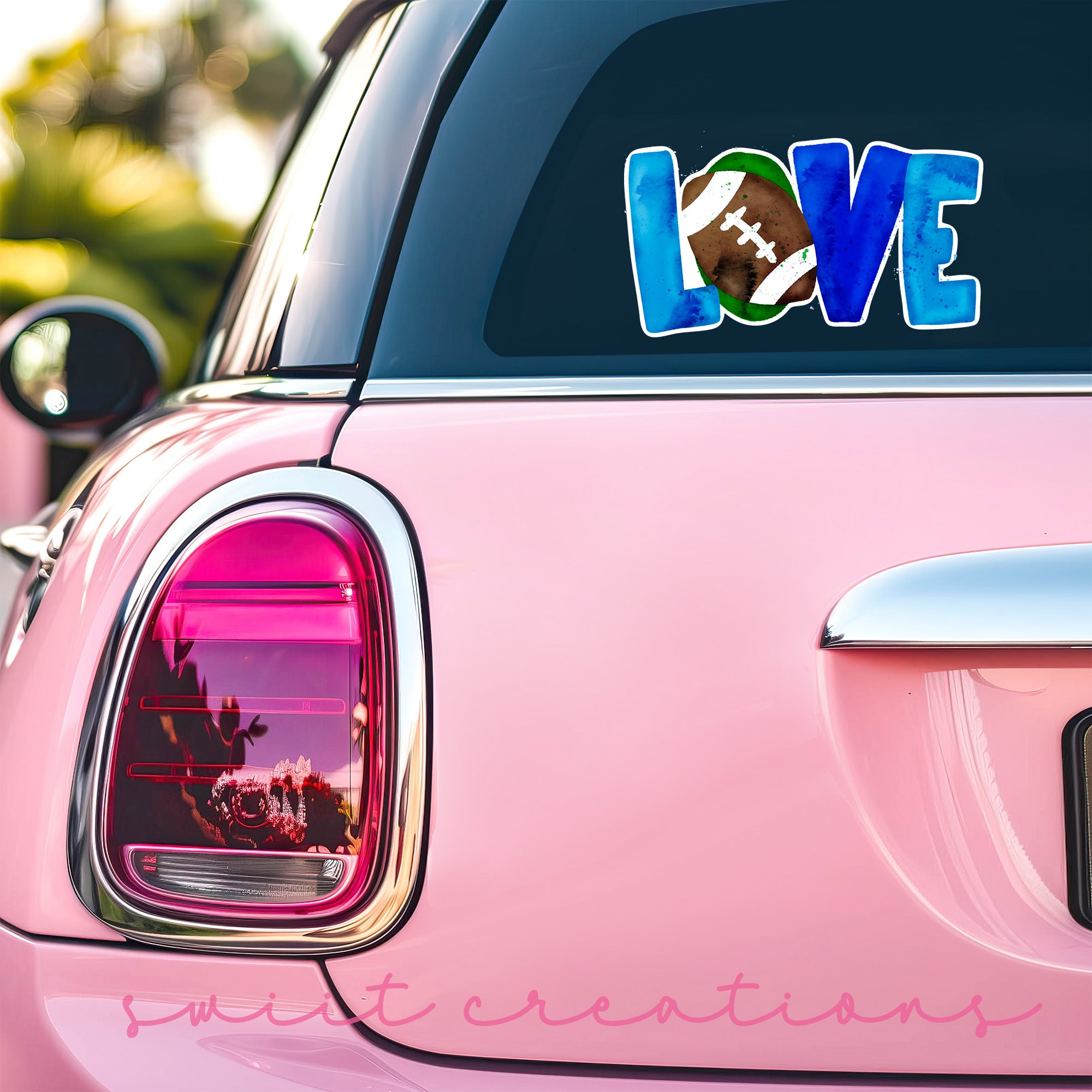 a pink car with a love football decal on it