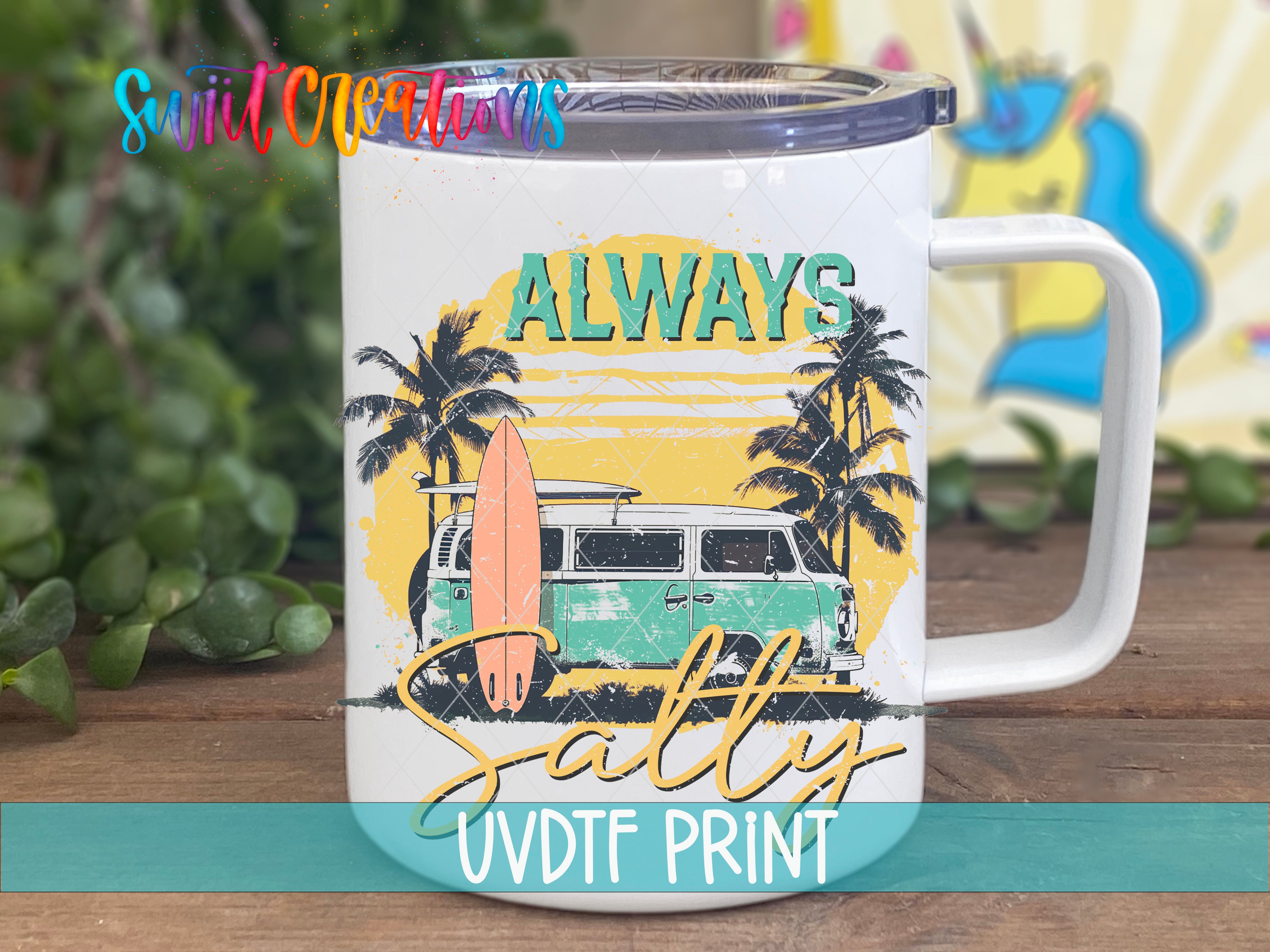 A white ceramic mug with a printed design featuring a surfboard, palm trees, and a vintage van, along with the text "ALWAYS SALTY UVDF PRINT".