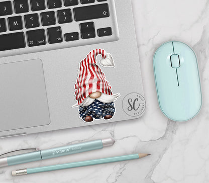 a laptop with a sticker of a gnome on it