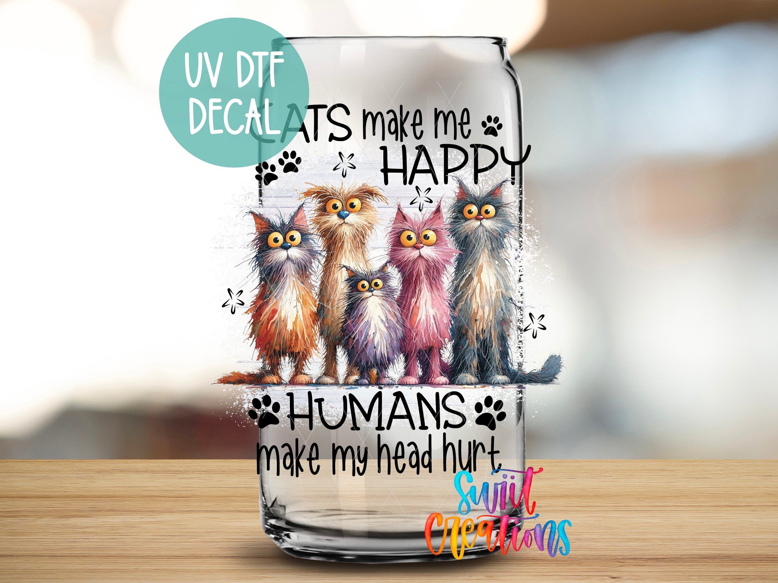 a glass with a picture of three cats on it