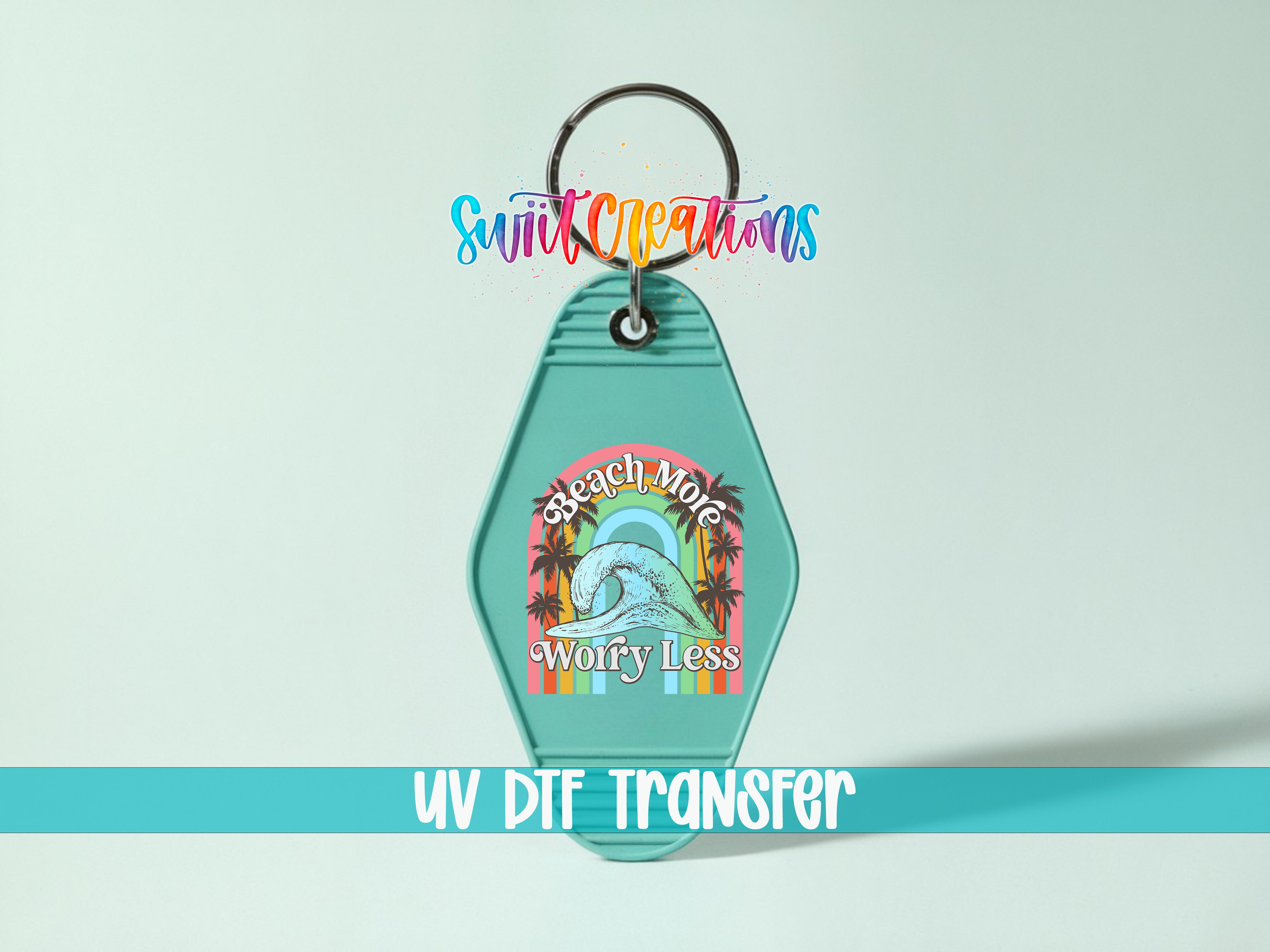 A keychain with a colorful graphic design and text, including the words "Sunrise More Worry Less" and "UV DIF TRANSFER".