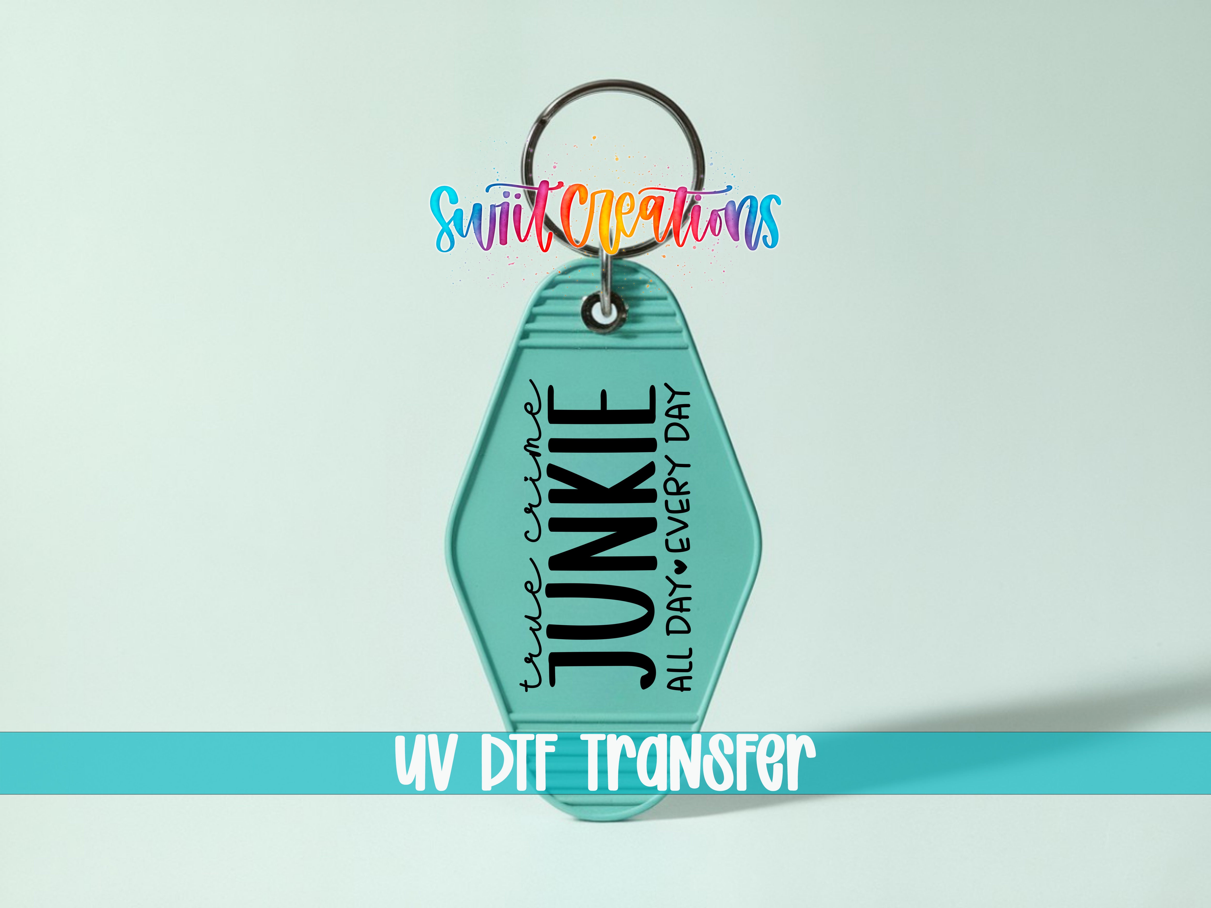 A keychain with the text "JUNKIE ALL DAY EVERY DAY" printed on it, along with a colorful logo. The keychain is set against a light blue background, and there is a text overlay that says "UV DIF TRANSFER".