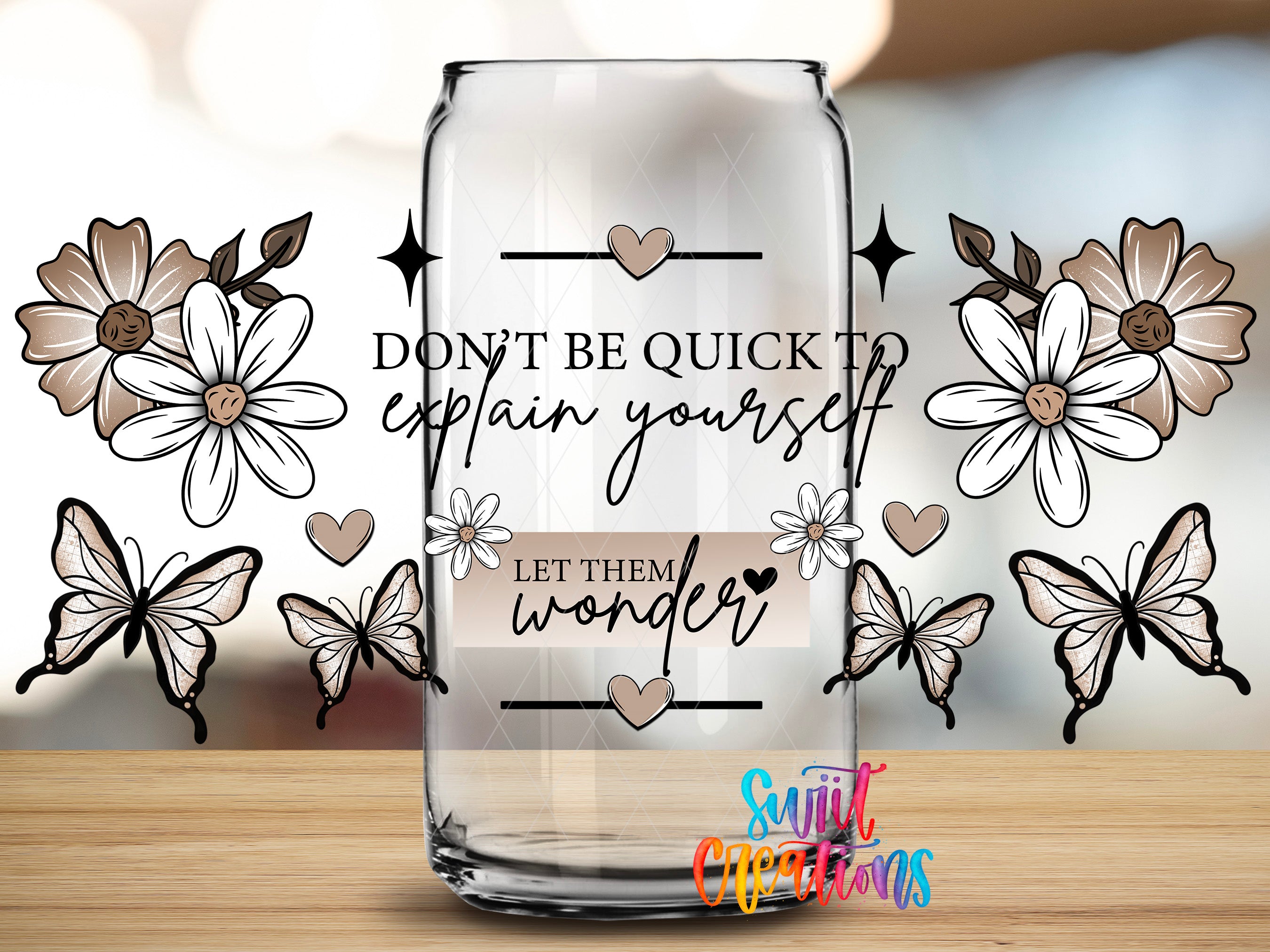 a clear glass can with a decorative design and text on it, surrounded by butterflies and flowers.