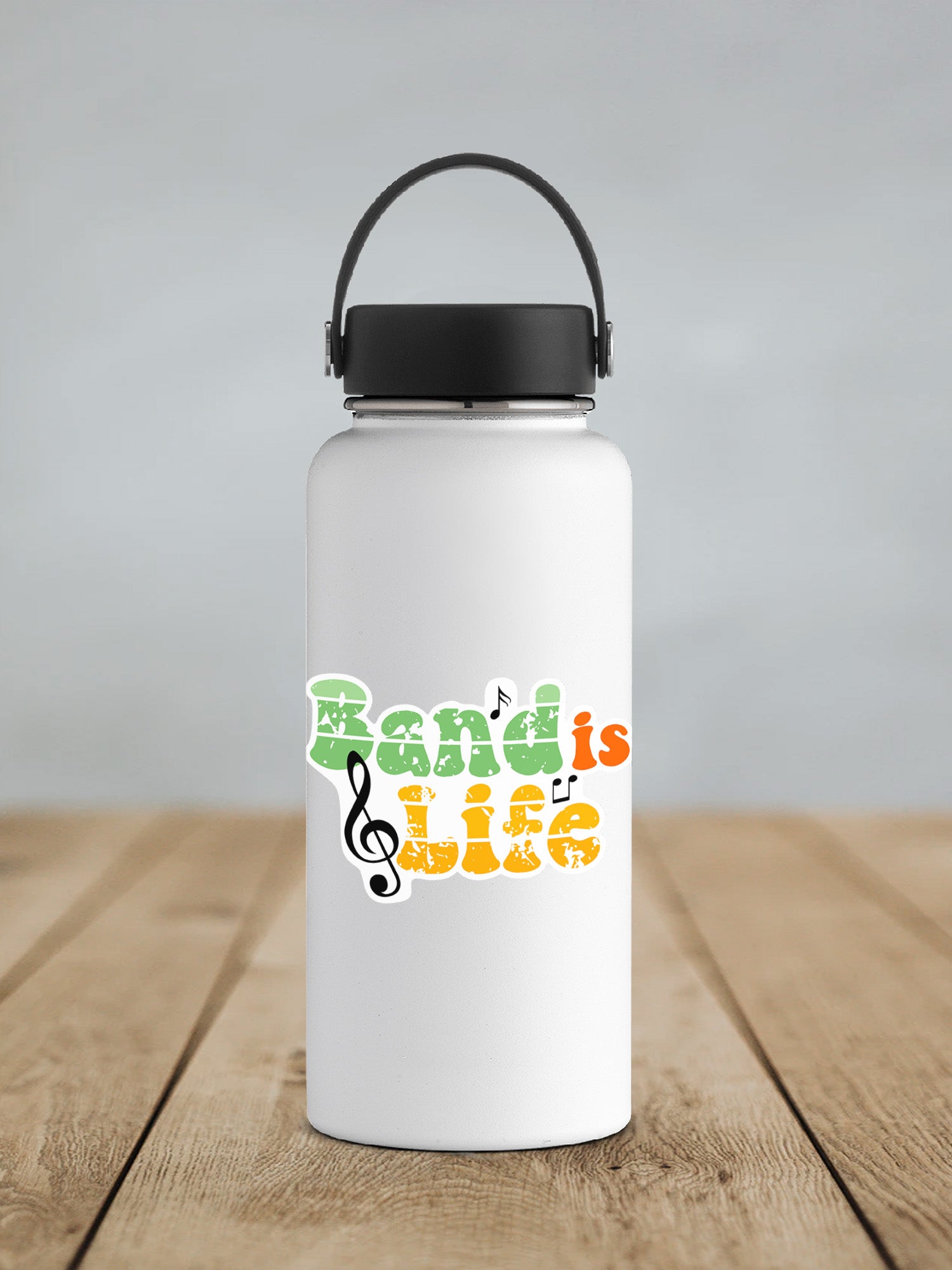 a white water bottle with a black lid on a wooden table