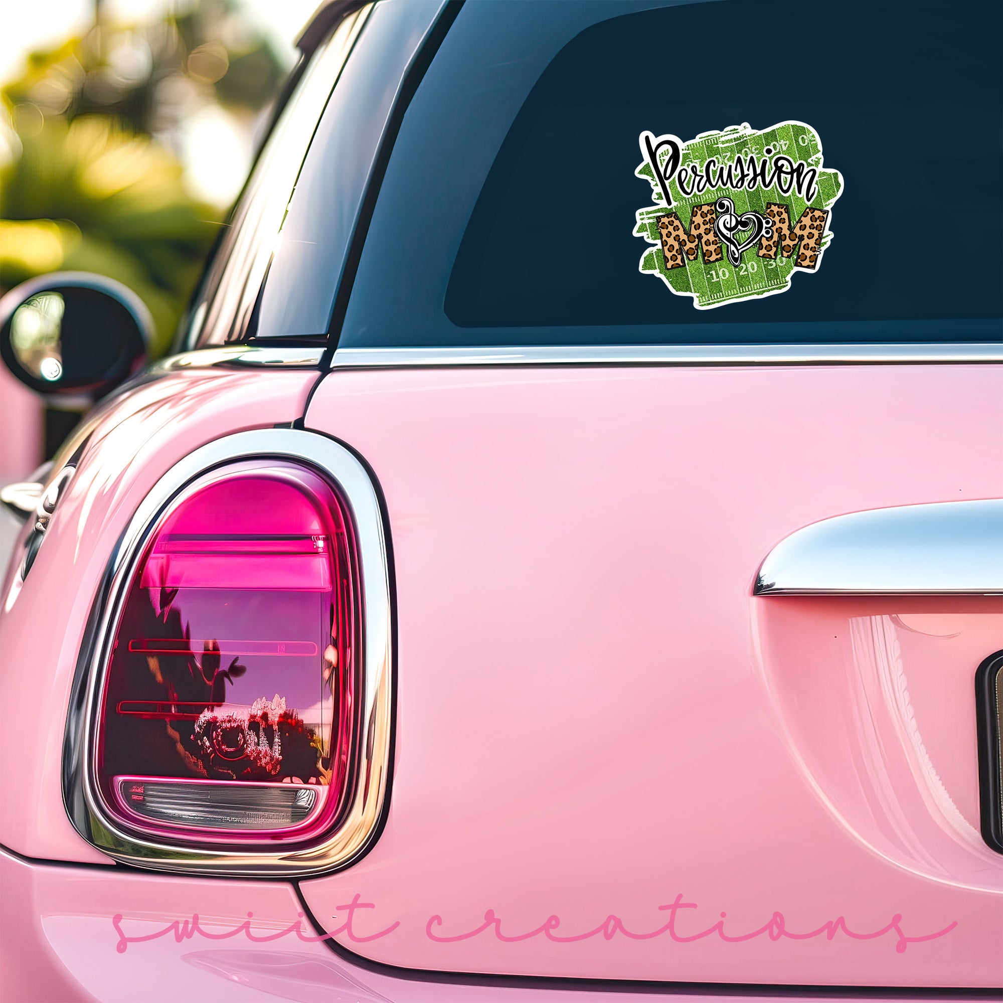 a pink car with a sticker on the back of it