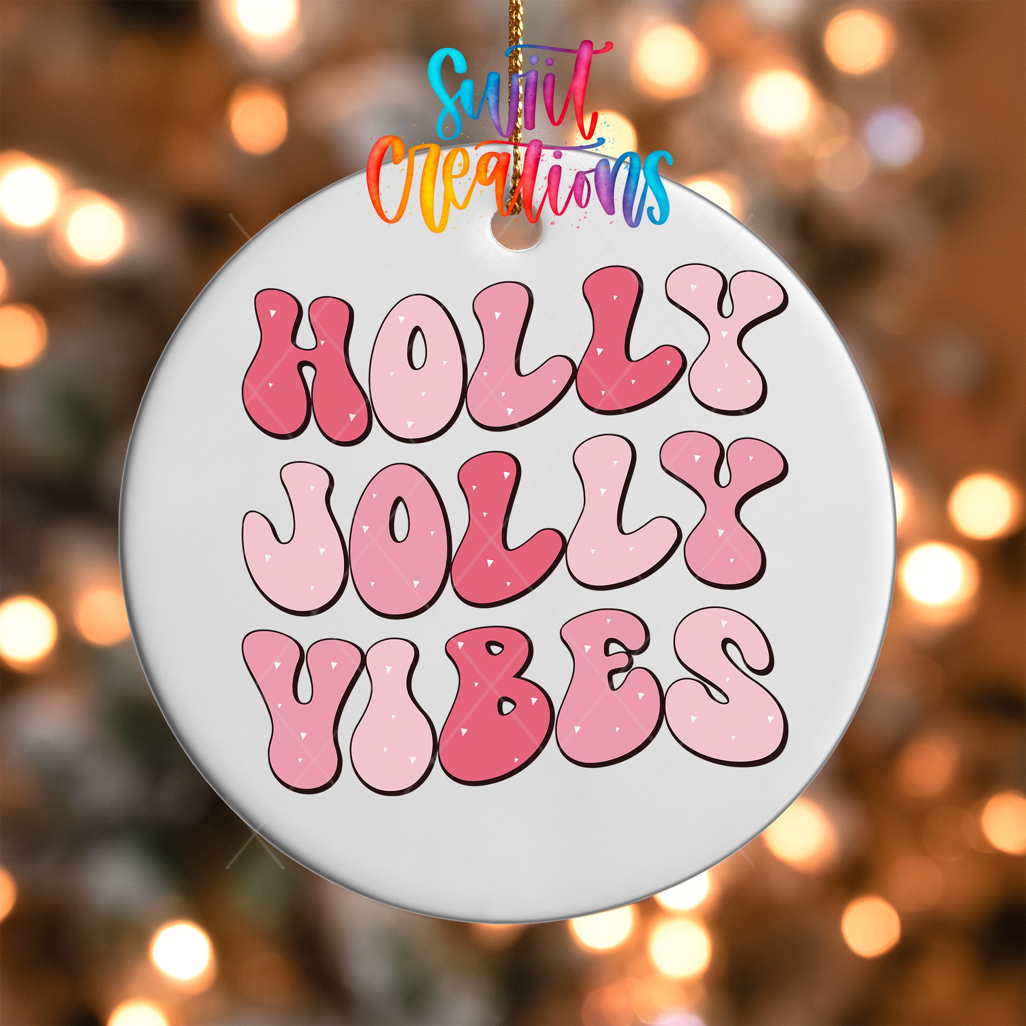 A white ornament with the text "HOLY JOYL VIBES" in pink and red letters.