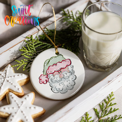 a festive scene with a Santa Claus ornament, a glass of milk, and two star-shaped cookies on a white tray.