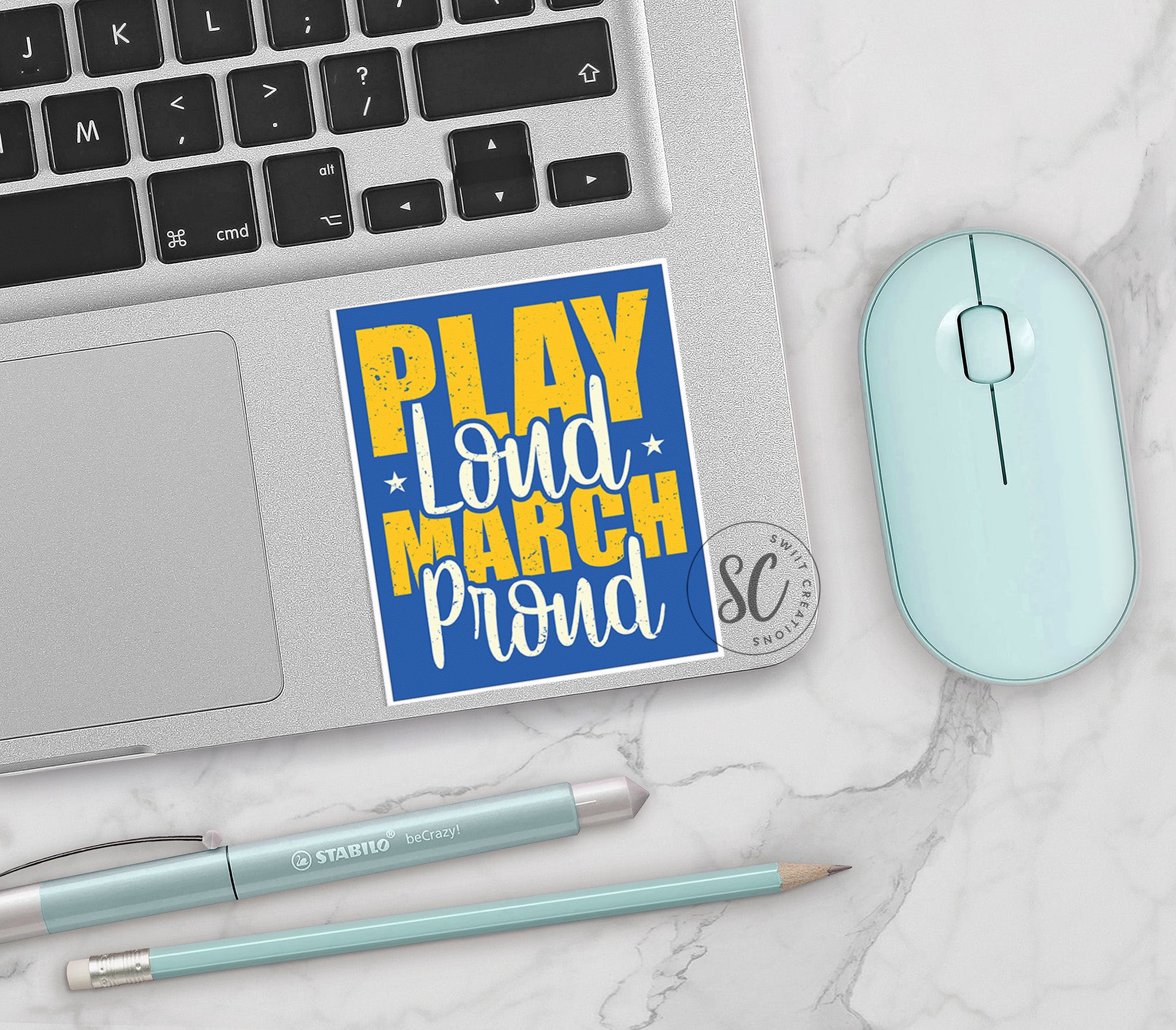 a keyboard, mouse, and sticker on a table